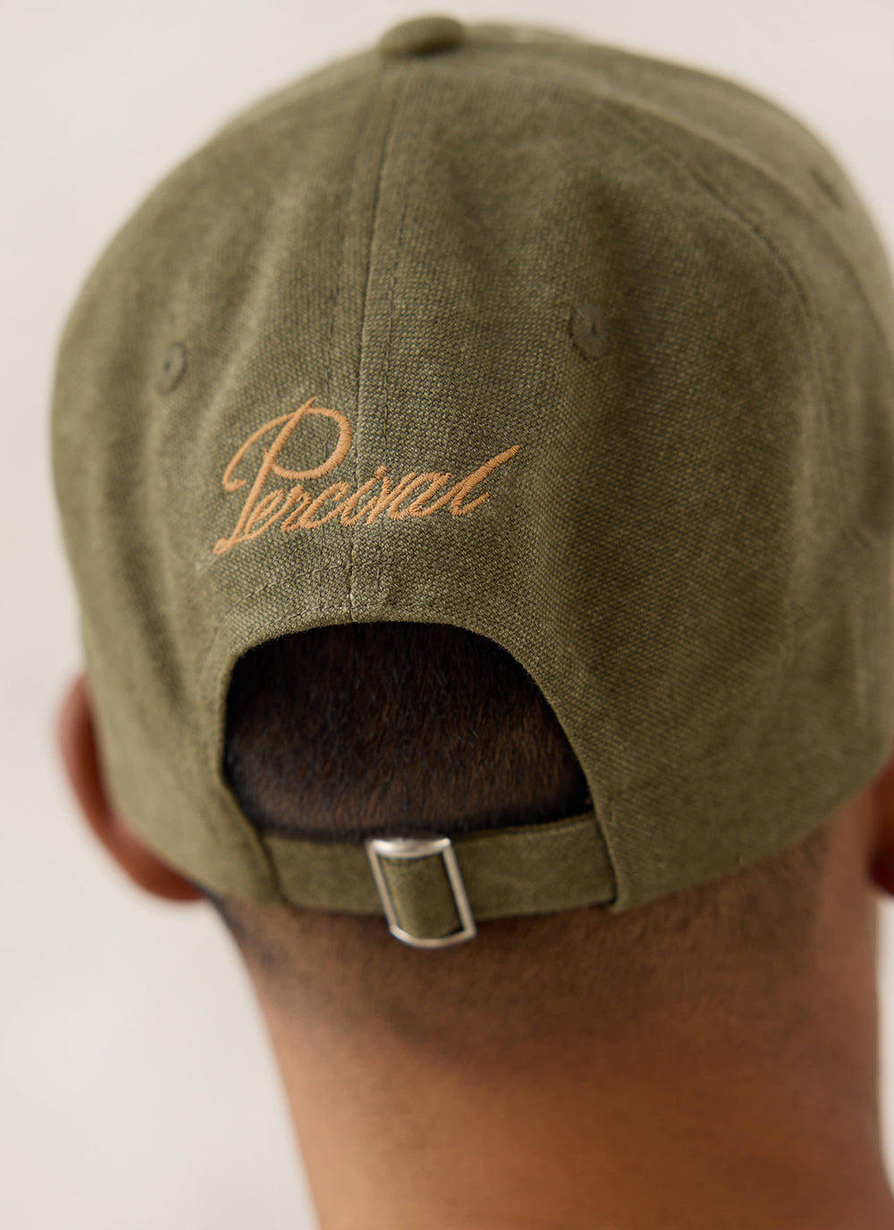 Rear view of the Guinness x Percival forest green cotton cap showing the adjustable back strap and embroidered branding.