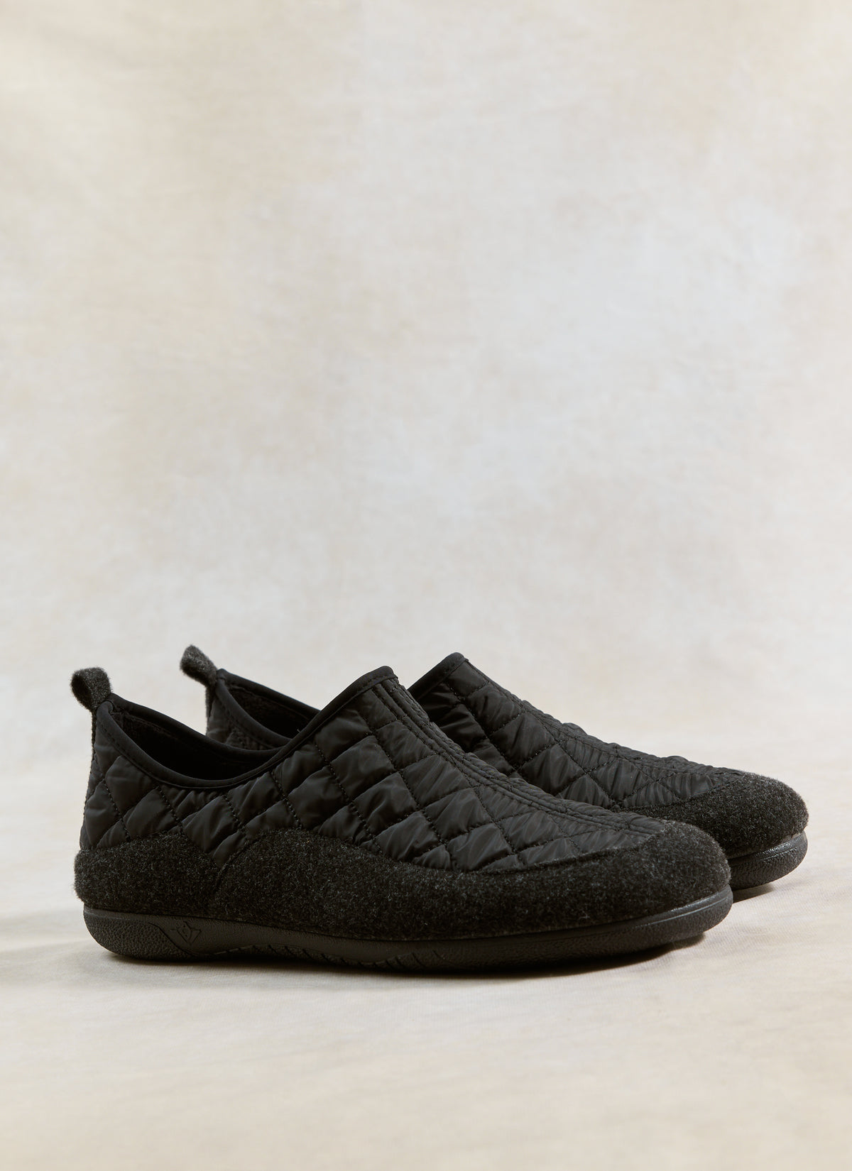 A pair of black Gurus Valencia Classic Homeshoes by Percival featuring a quilted nylon upper and brushed felt foxing tape.