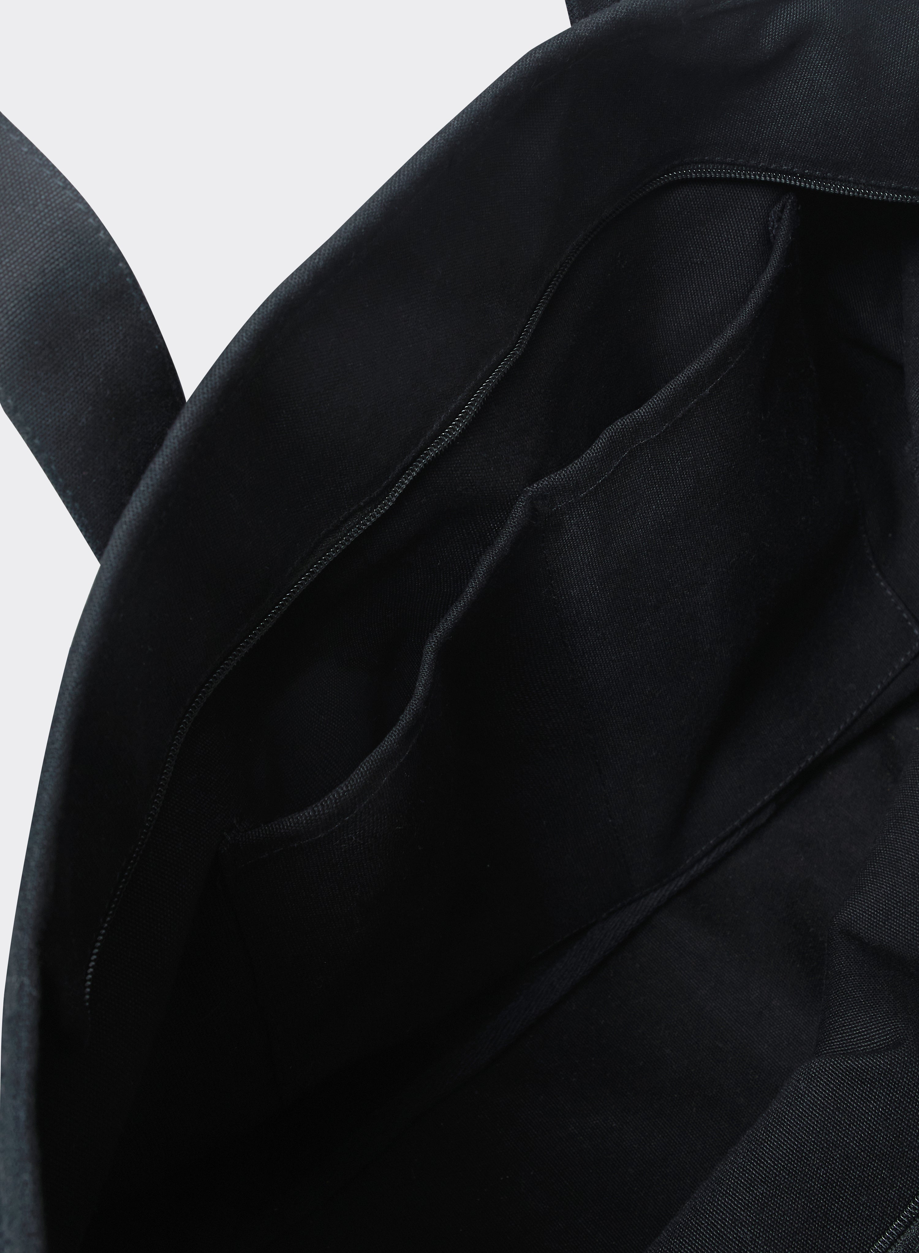 The black cotton interior of the Percival Kingsley Large Tote Bag, highlighting internal pockets and a zip closure.