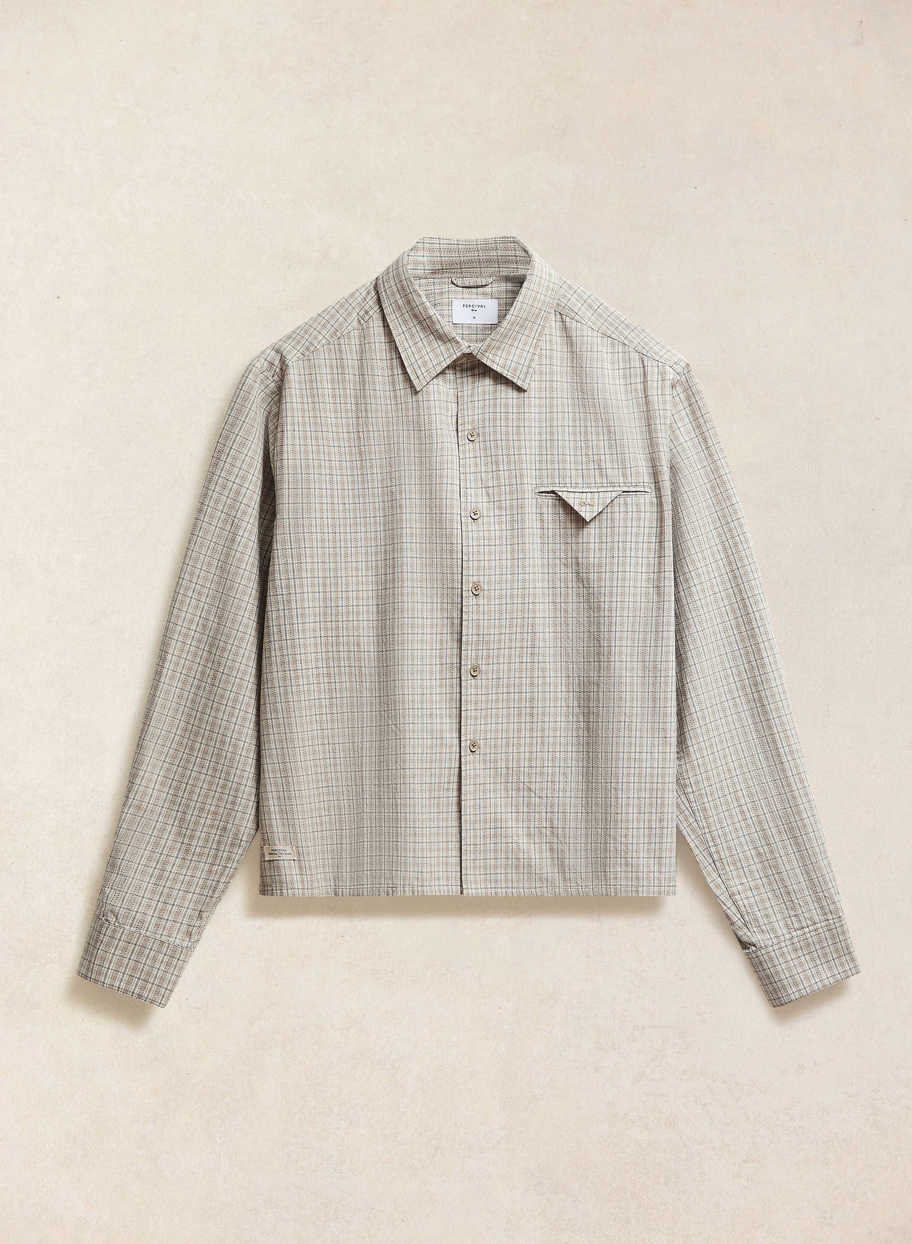 Flat lay of the cream check Hinsley long sleeve shirt from Percival, showcasing the 100% cotton fabric and chest pocket.