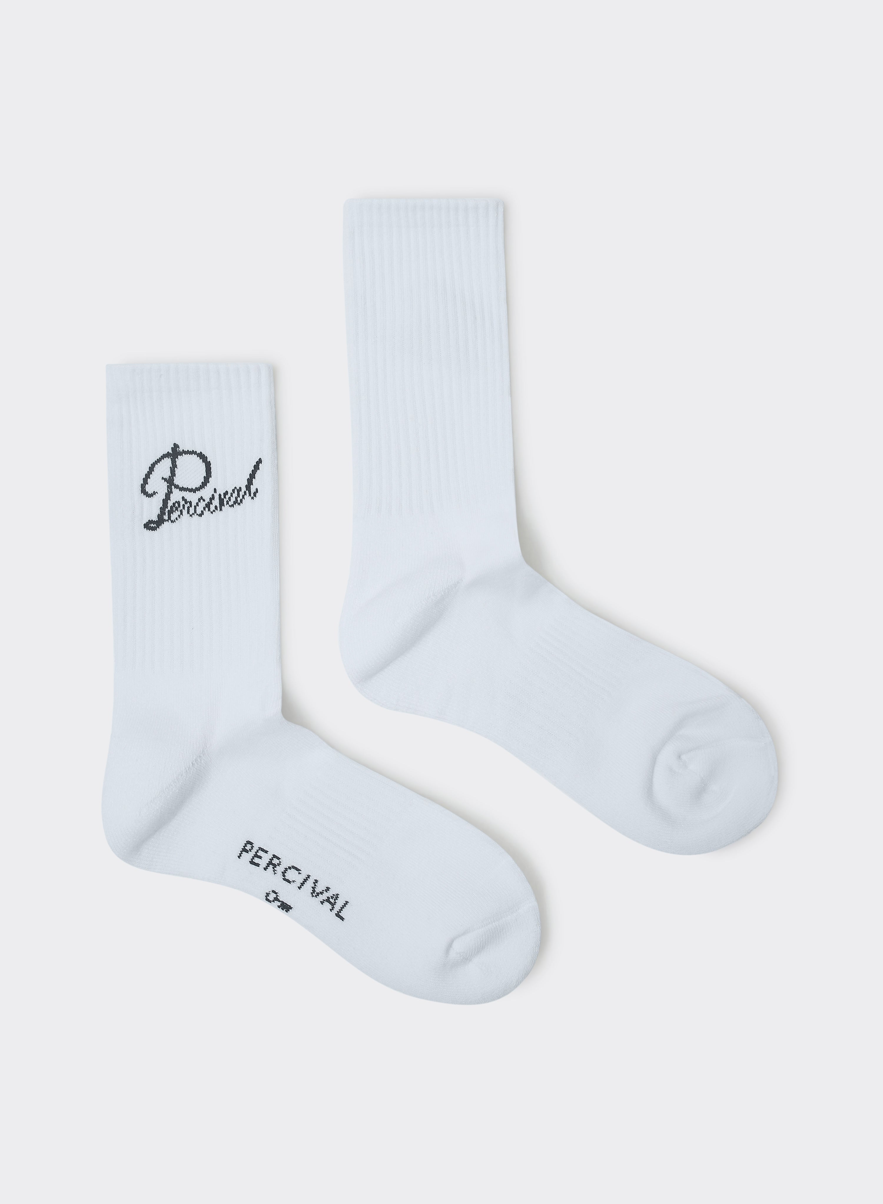 White Percival Kingsley Jacquard Socks in ribbed cotton with script logo embroidery, shown flat against a grey background.