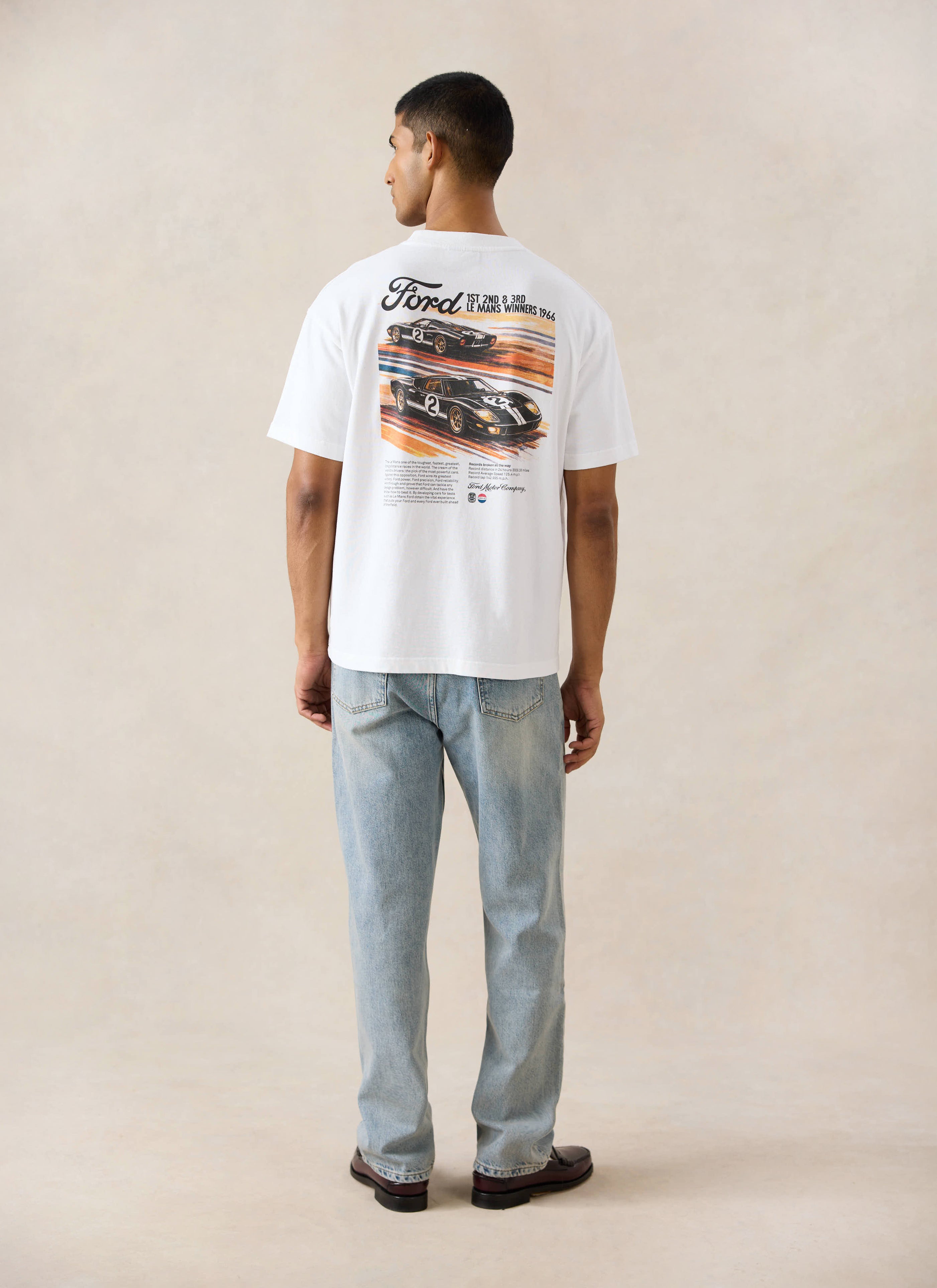White Ford x Percival Le Mans oversized T-shirt with a racing back graphic, styled with Percival heritage denim jeans.