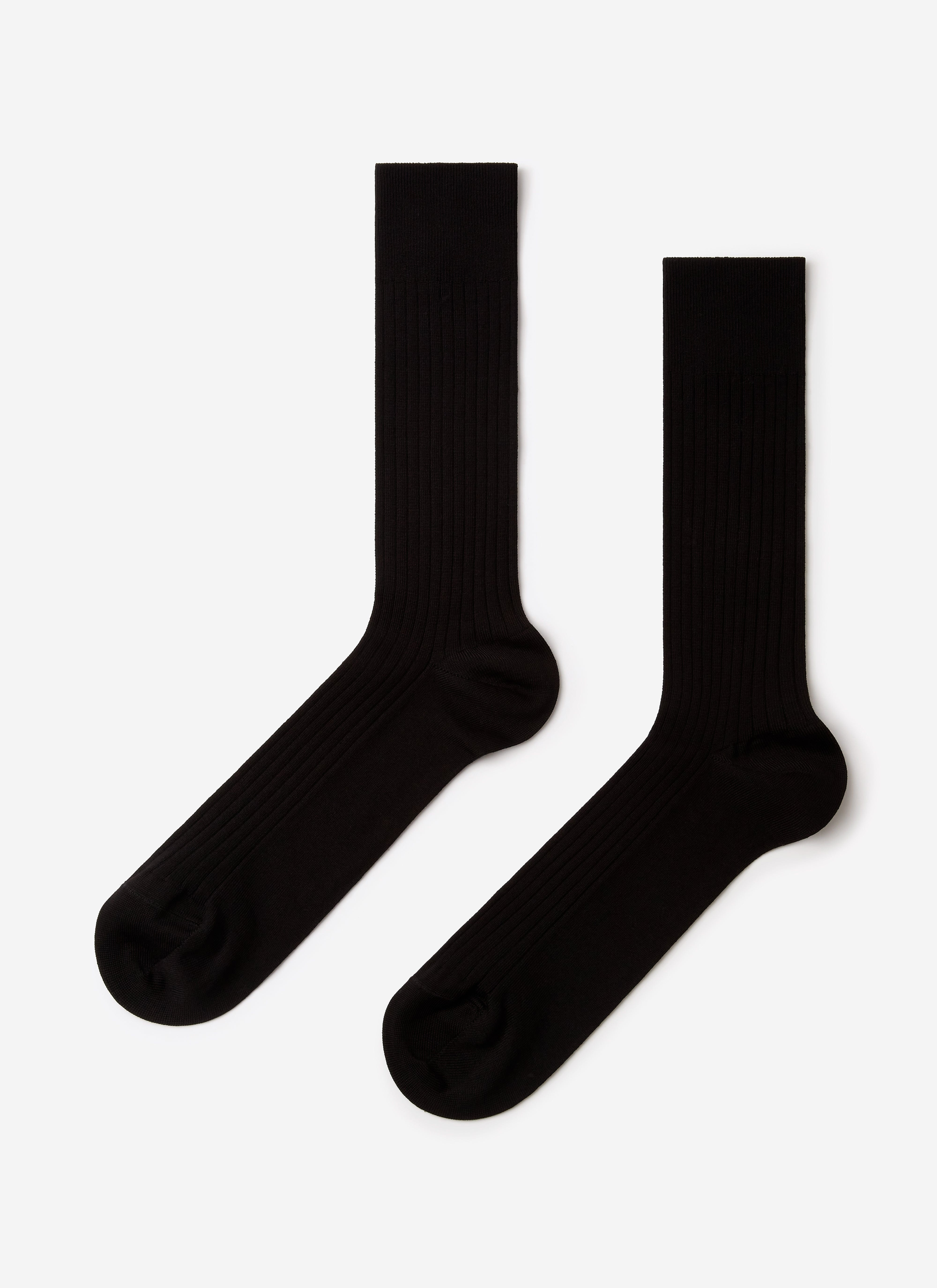 A pair of black Percival Loafer Dress Socks, showing their ribbed texture, laid flat against a white background.