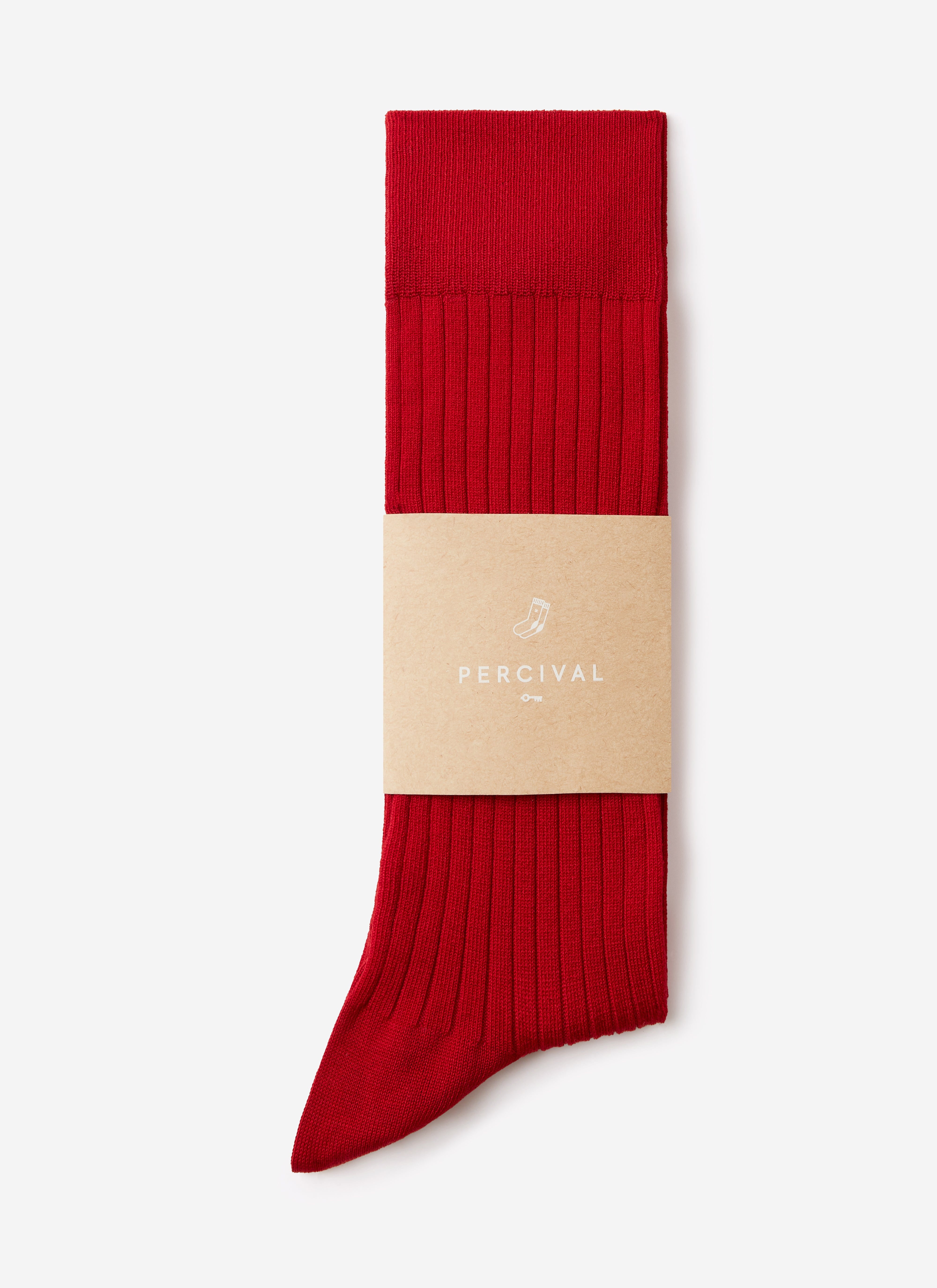A pair of Percival's red ribbed Loafer Dress Socks, folded and presented in a branded paper sleeve on a plain background.