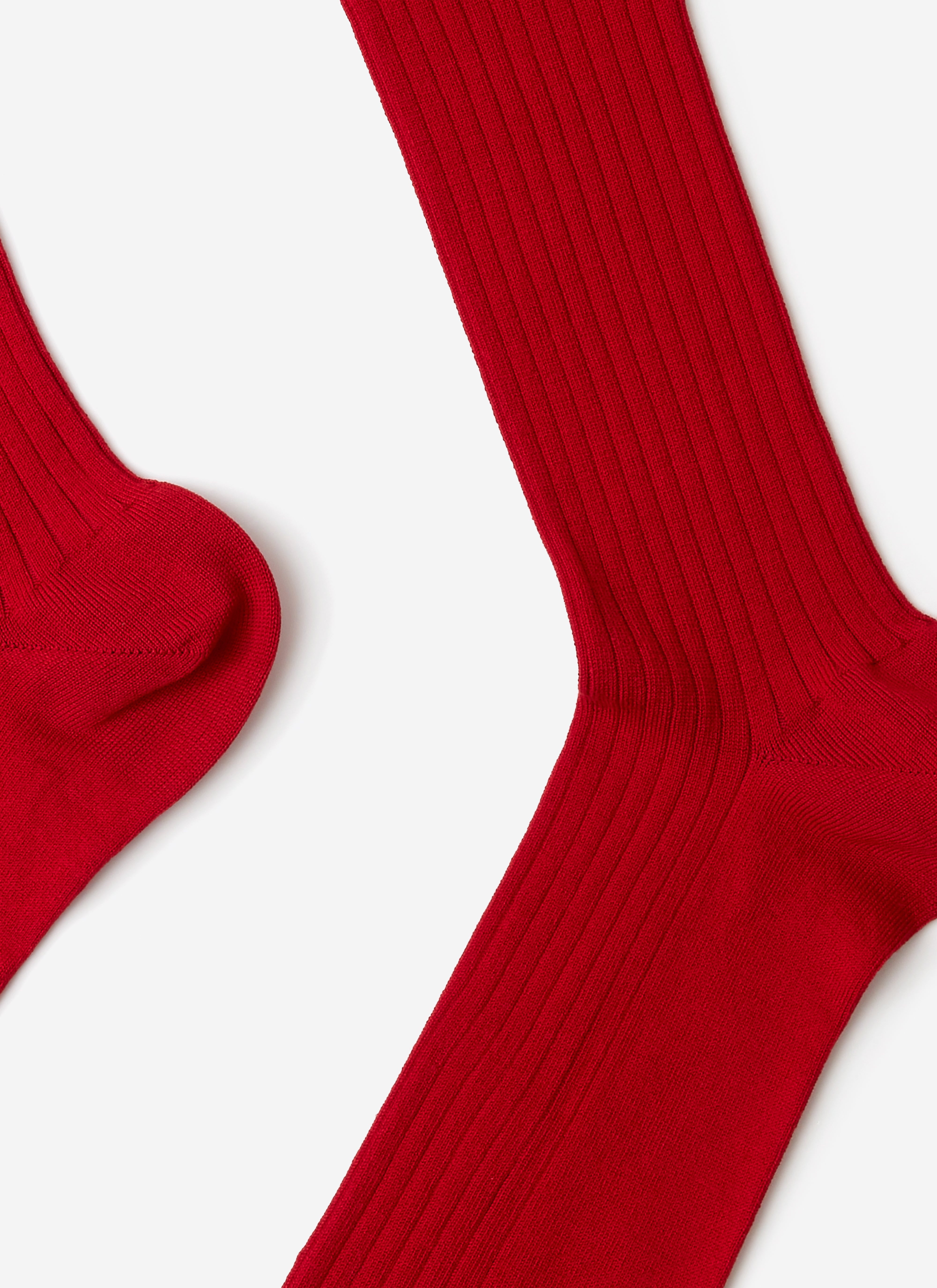 A close-up of the Percival Loafer Dress Socks in red, highlighting the soft, ribbed cotton-blend texture.