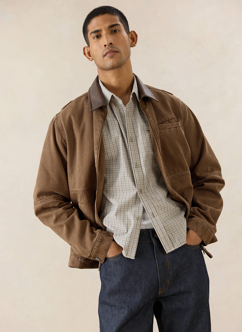 A model wears the mocha brown Percival Lucas Contrast Collar Jacket, styled with a checked shirt and dark denim jeans.