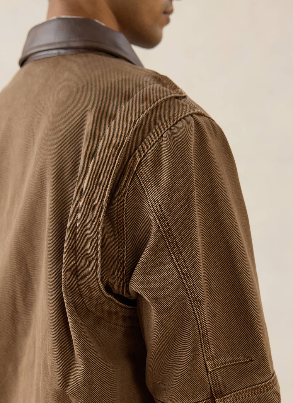 A close-up of a model wearing the mocha brown Percival Lucas contrast collar jacket, highlighting the cotton twill texture.