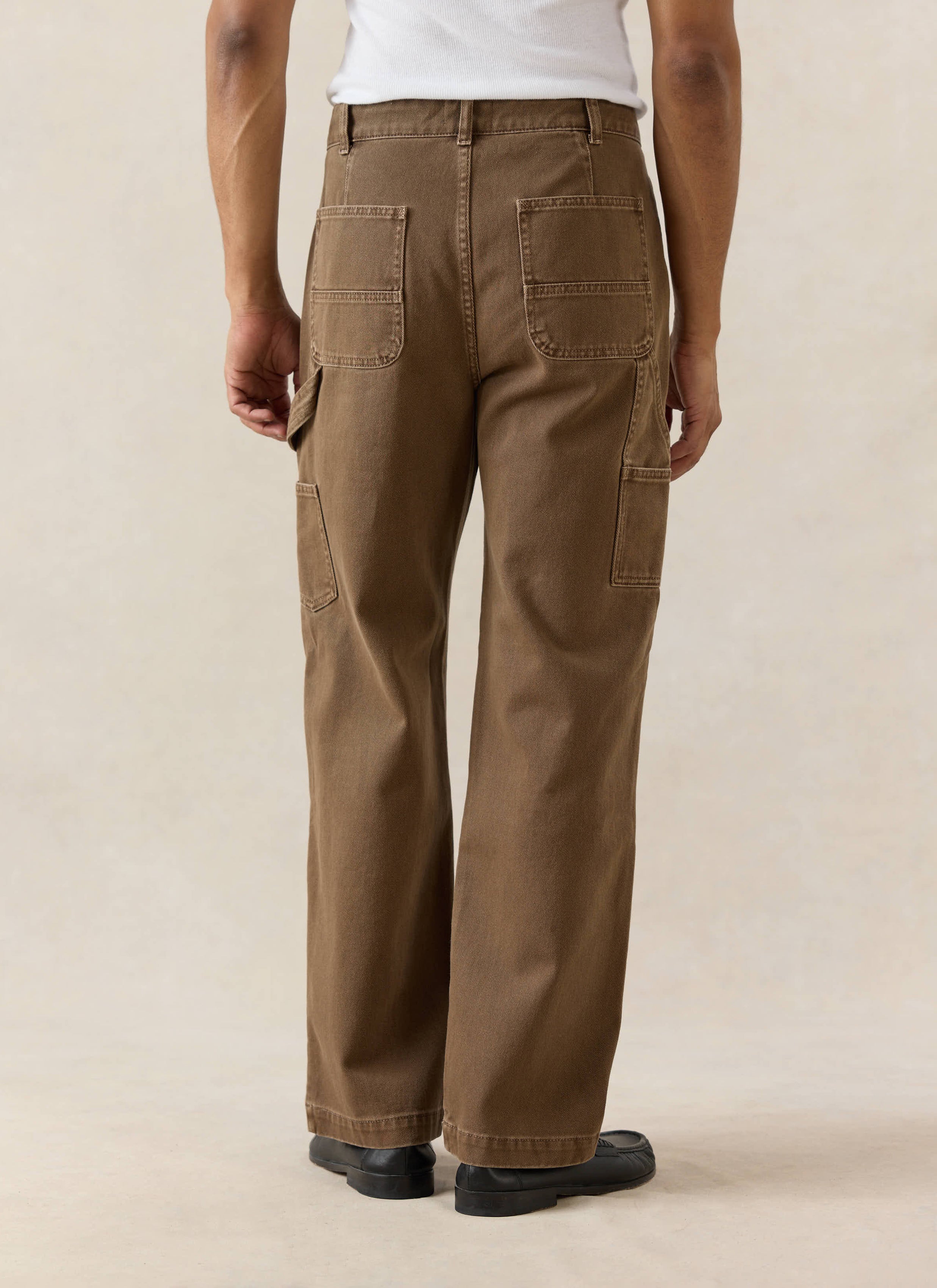 Espresso brown Percival Lucas Carpenter trousers in cotton, featuring a hammer loop and straight leg, shown from behind.