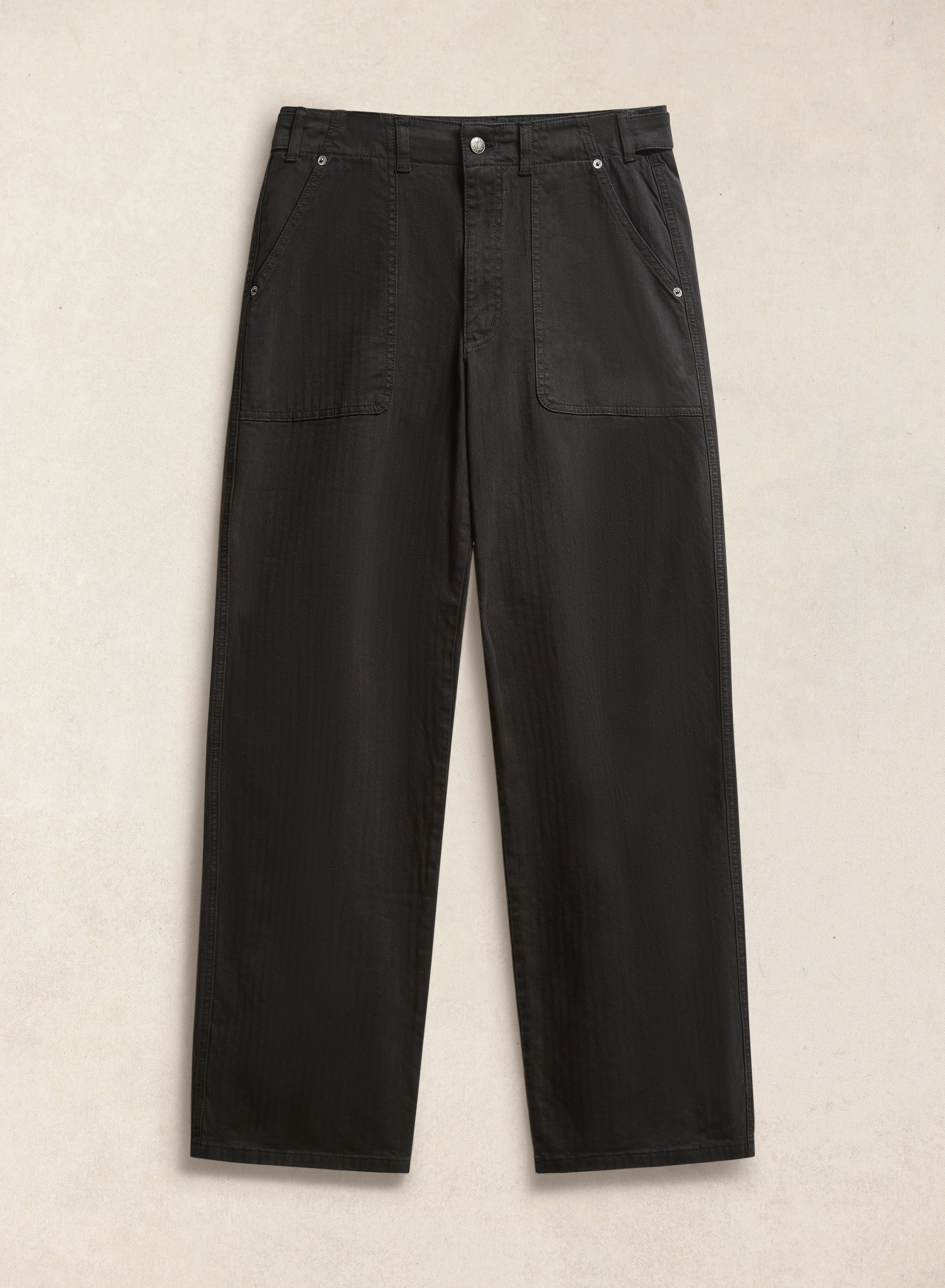 The black Percival Lungo Carpenter Trousers in cotton herringbone, featuring utility-inspired front patch pockets.