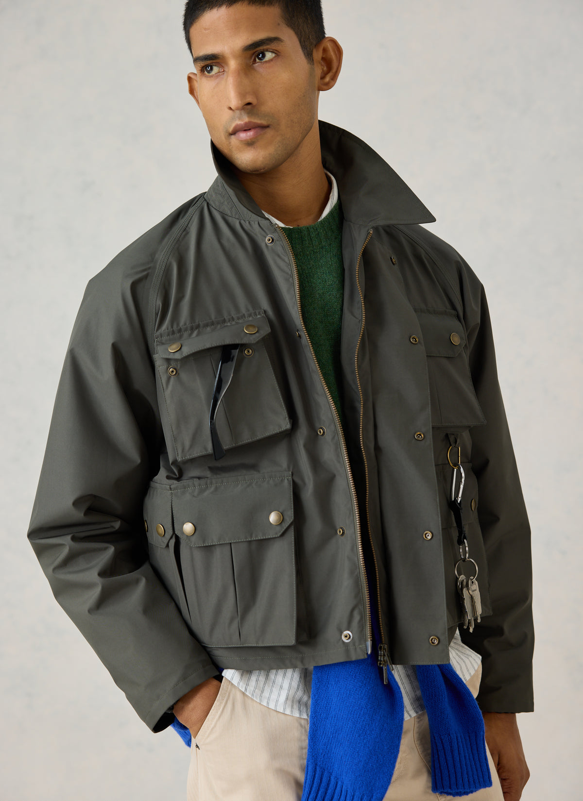 A model wearing the Percival forest green Hunter Field Jacket with four front pockets and turned-up collar.