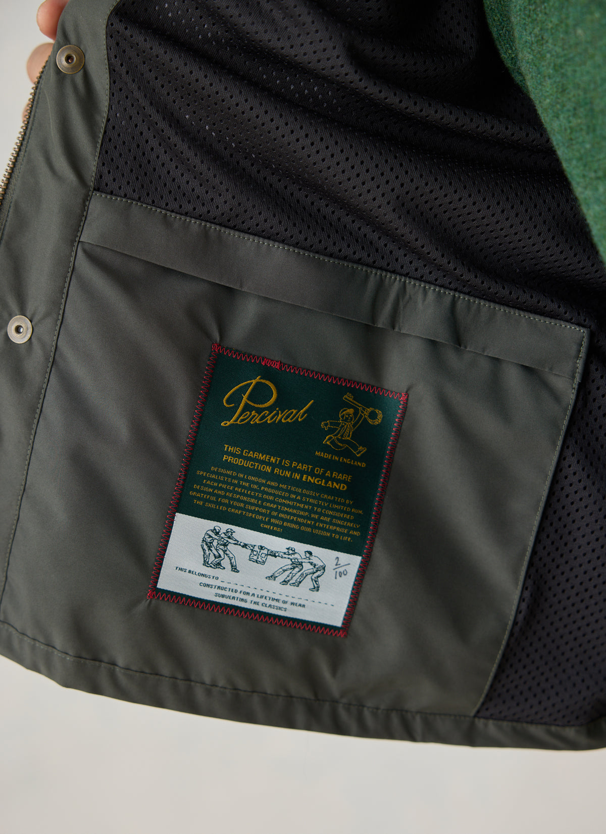 Close-up of the forest green Percival Hunter Jacket interior showing the mesh lining and Made in England label.