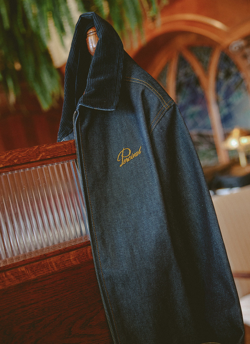 Percival Mackey zip jacket in raw indigo denim featuring a contrast cord collar and chest embroidery.
