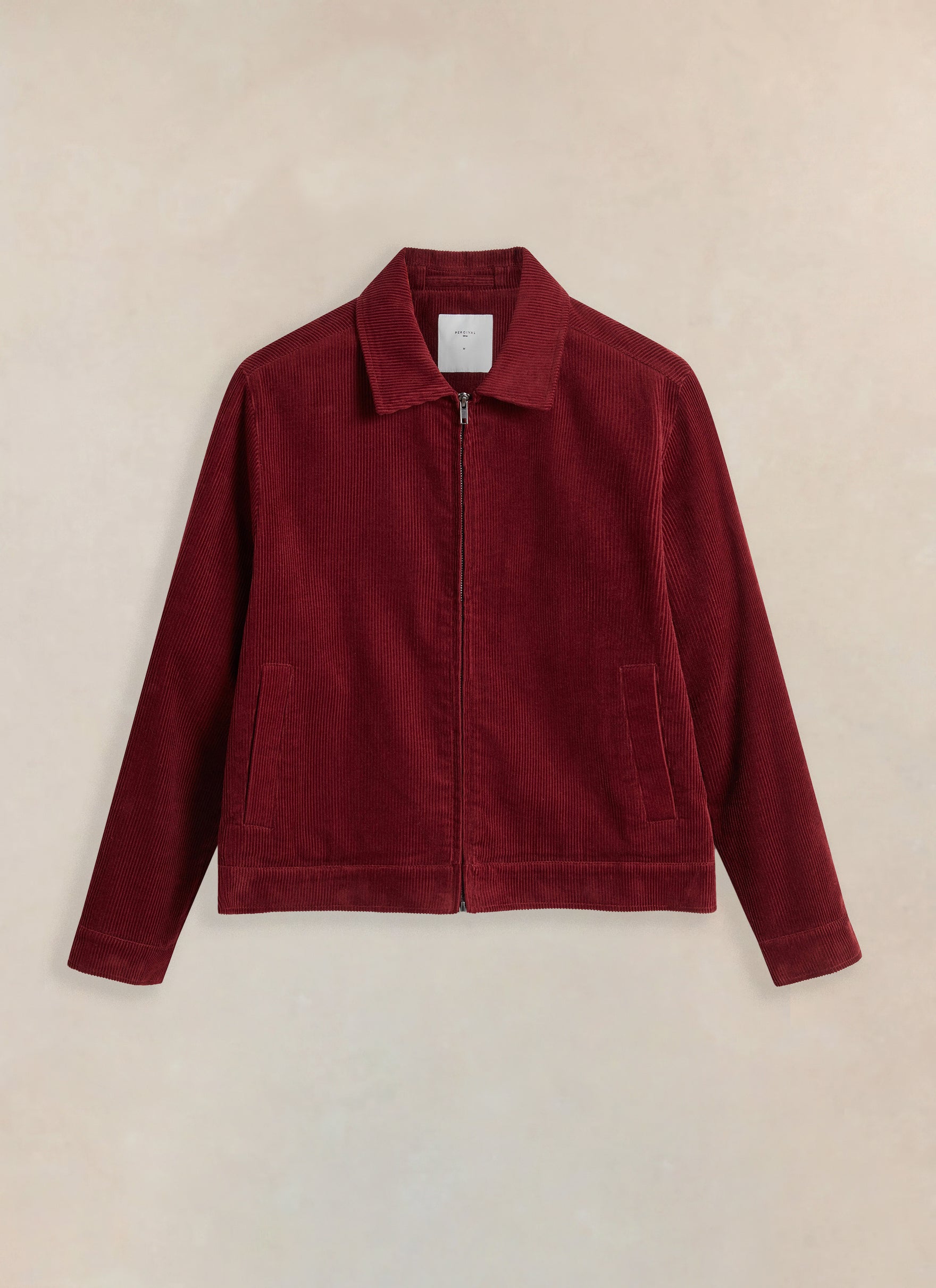 Studio product shot of the burgundy Marcel Cord Jacket from Percival against a neutral background.