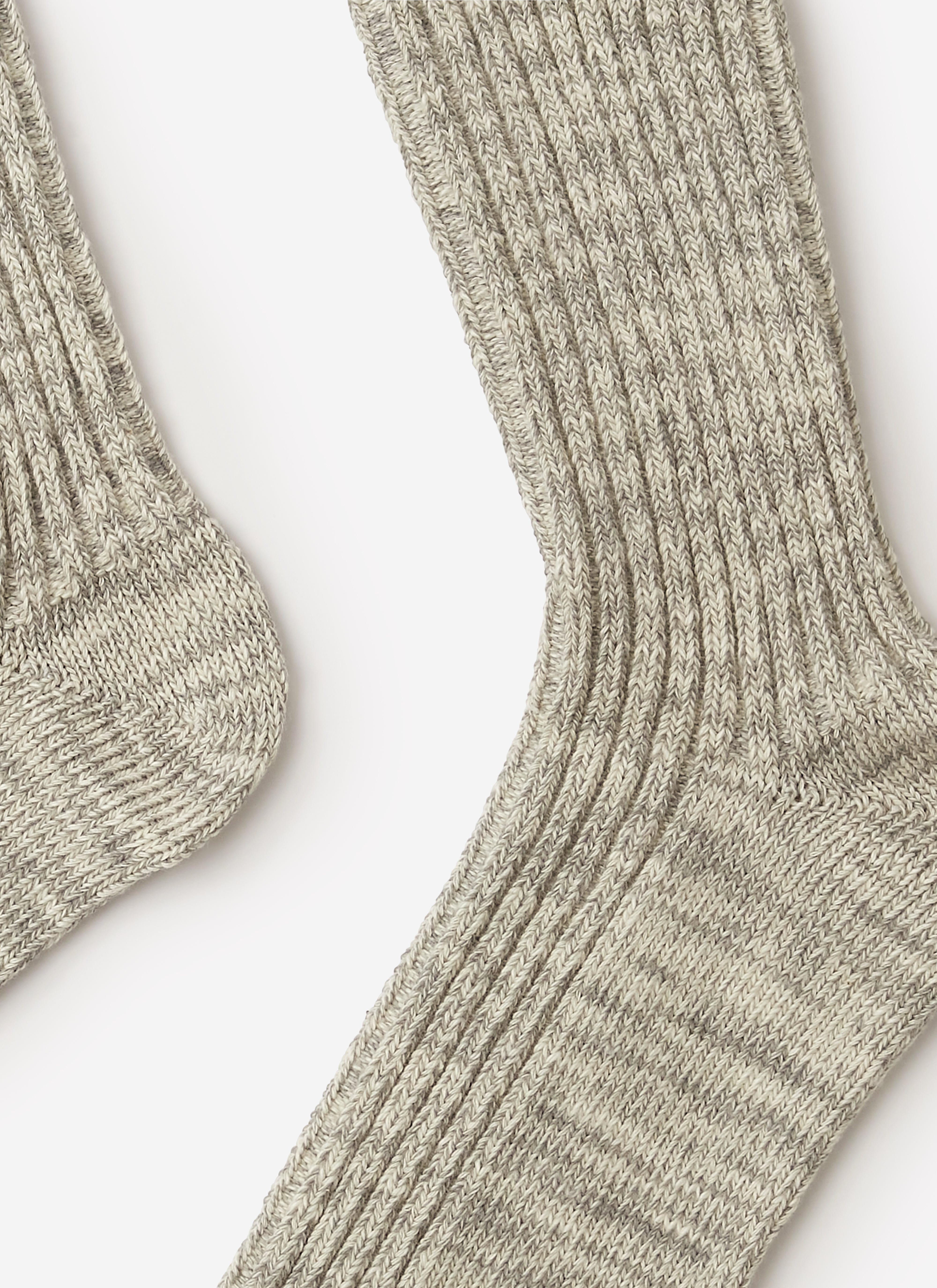 A close-up studio shot of the grey marl ribbed cotton socks from Percival, showing the texture of the knit.