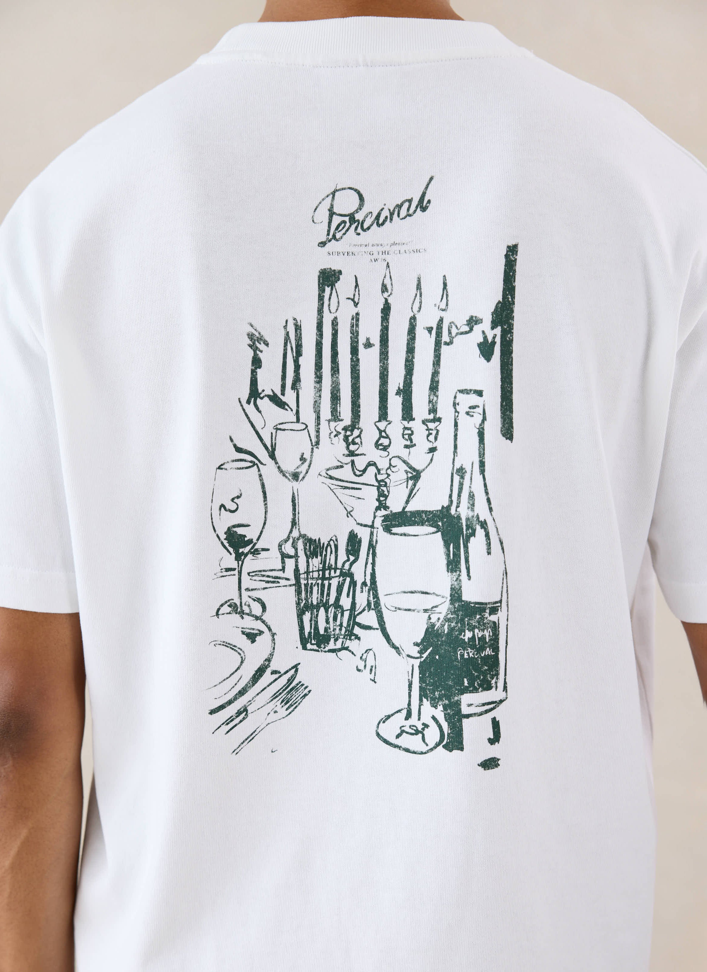 White organic cotton Percival T-shirt with a detailed dining scene back graphic, shown from behind on a model.