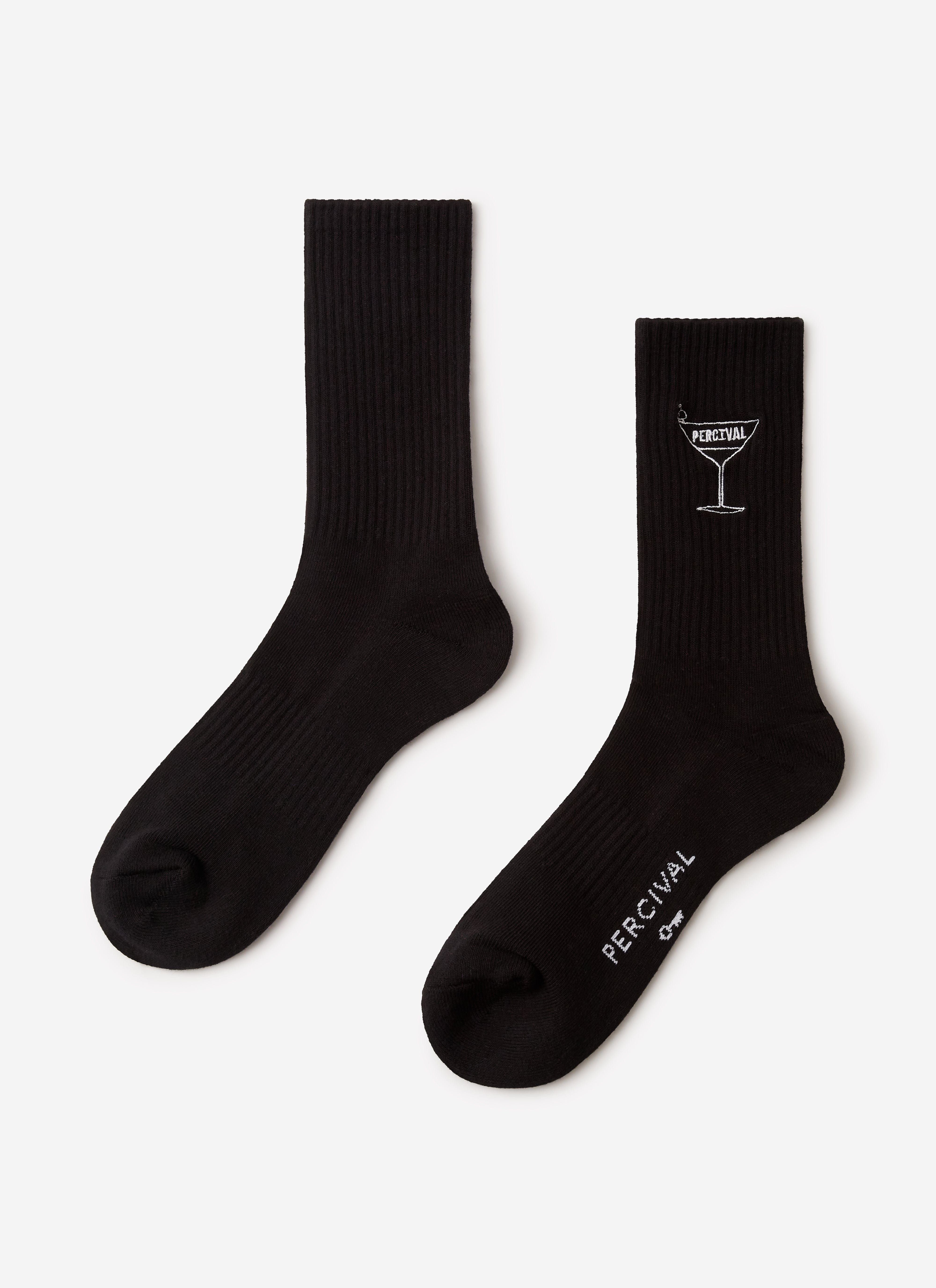 A pair of black Percival Martini Embroidered Socks laid flat, showing the white cocktail glass embroidery and logo detail.