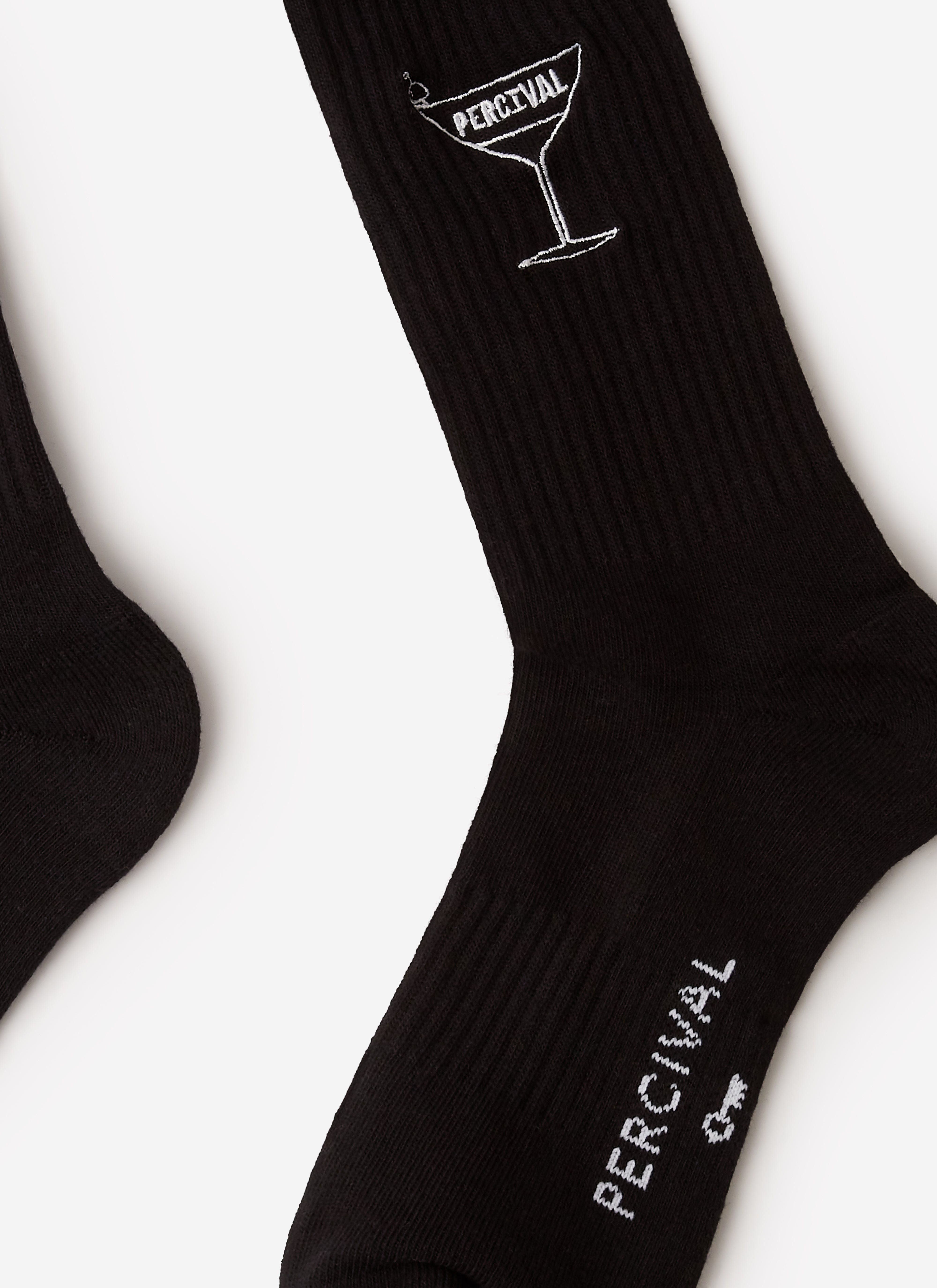 A close-up of the Percival Martini Embroidered Socks in black, showing the signature white martini glass logo embroidery.