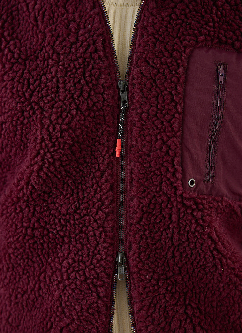 Close-up of the burgundy wool blend Percival fleece jacket, showing the two-way zipper and chest pocket details.