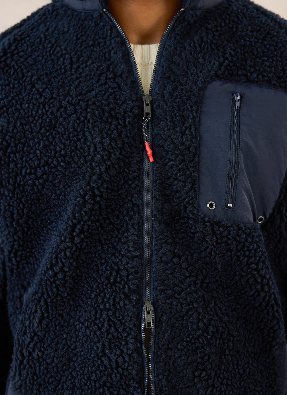 Close-up of the navy Percival wool blend fleece jacket, highlighting the two-way zip and contrast chest pocket.
