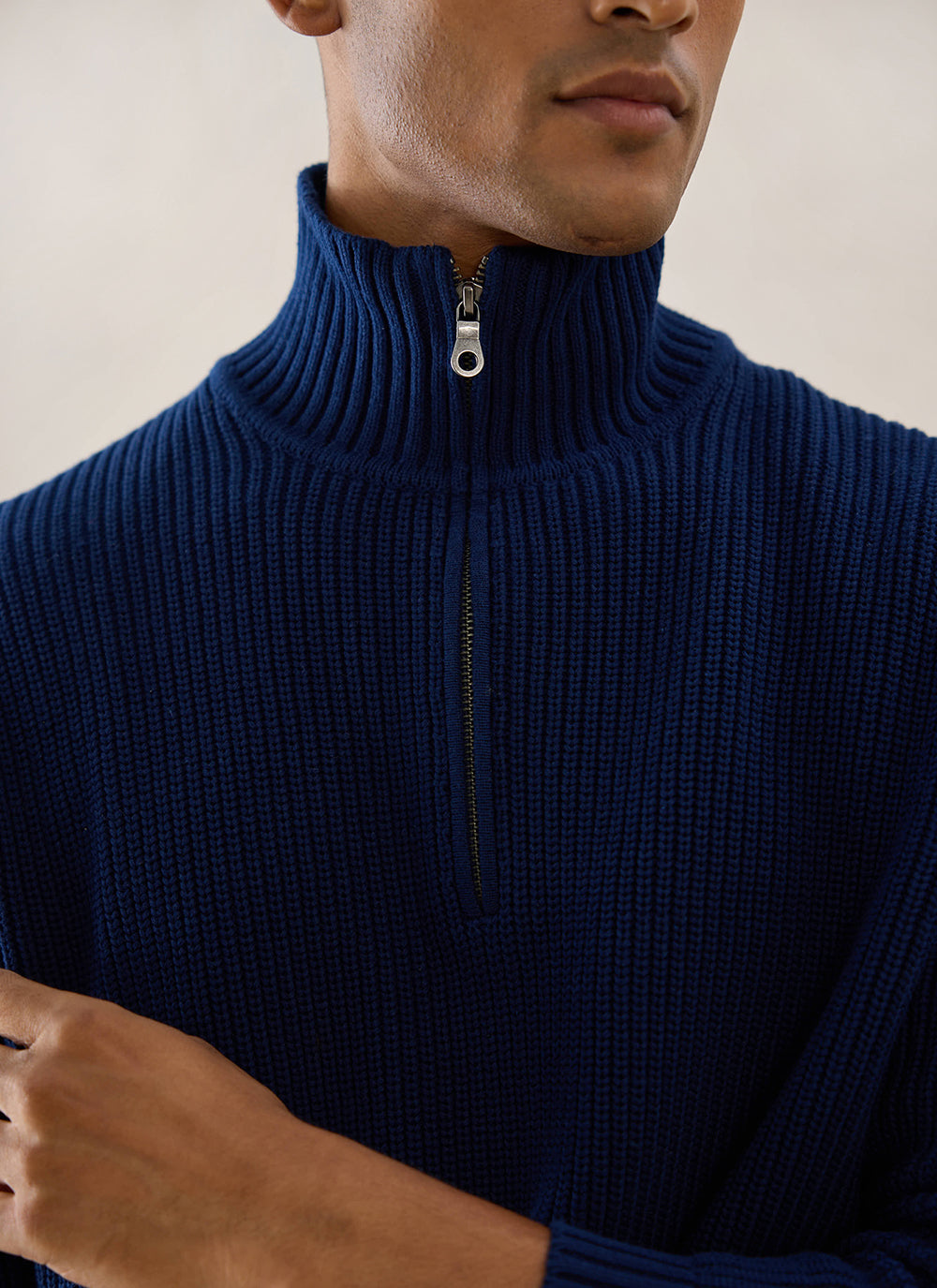 Close-up of a model wearing the navy Percival Meyer Boxy Quarter Zip, highlighting the ribbed funnel collar and zip detail.