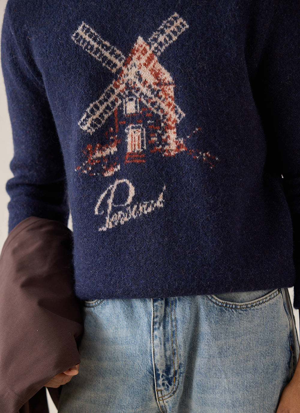 Close-up of the navy Percival Miller jacquard jumper showcasing the windmill knit design and script branding.