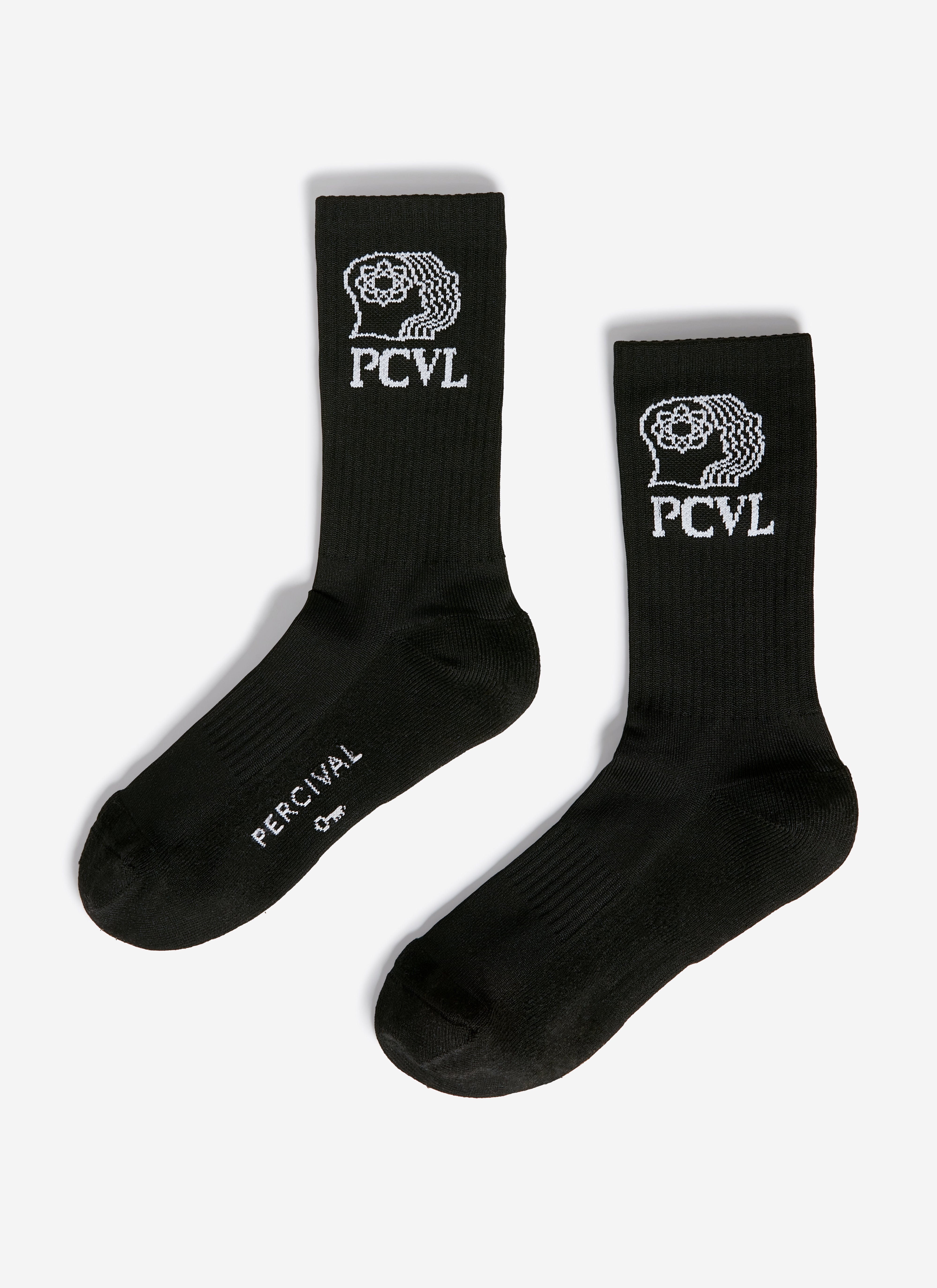 A flat lay of the black PCVL Sport Socks from Percival, showing the white jacquard logo graphic on the ribbed cuff.