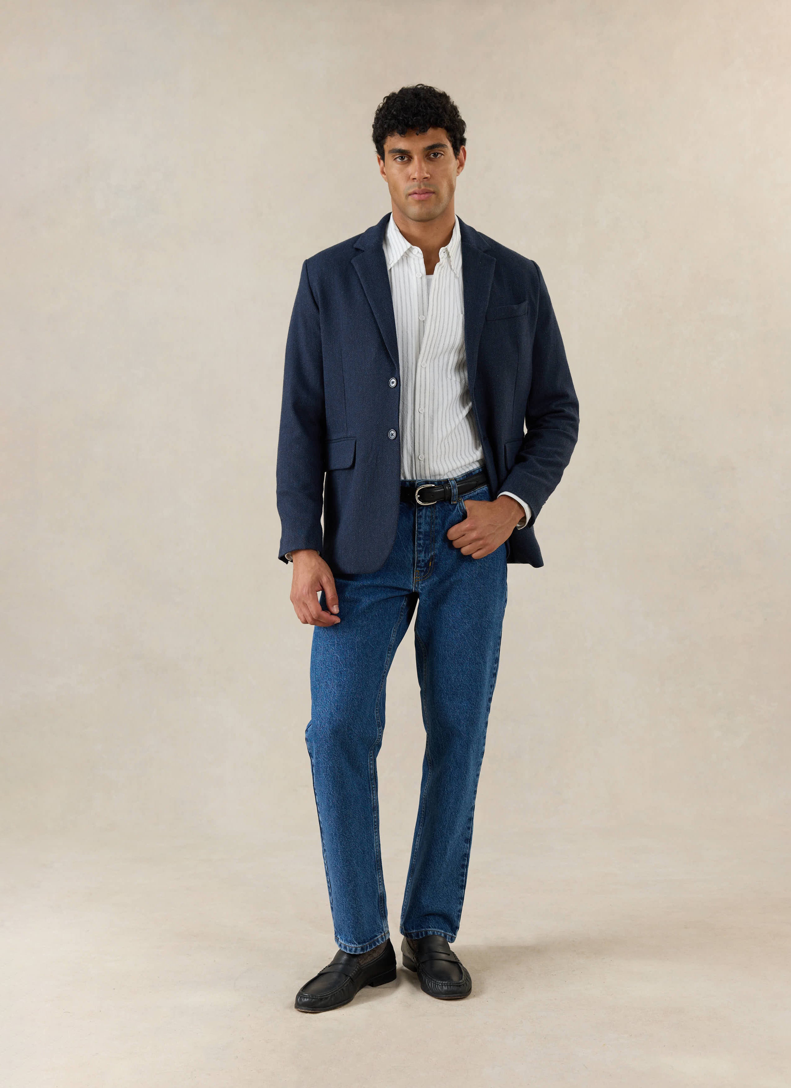 Percival Stanley Tailored Blazer in Navy Herringbone Wool, worn by a model with a striped shirt and blue jeans.