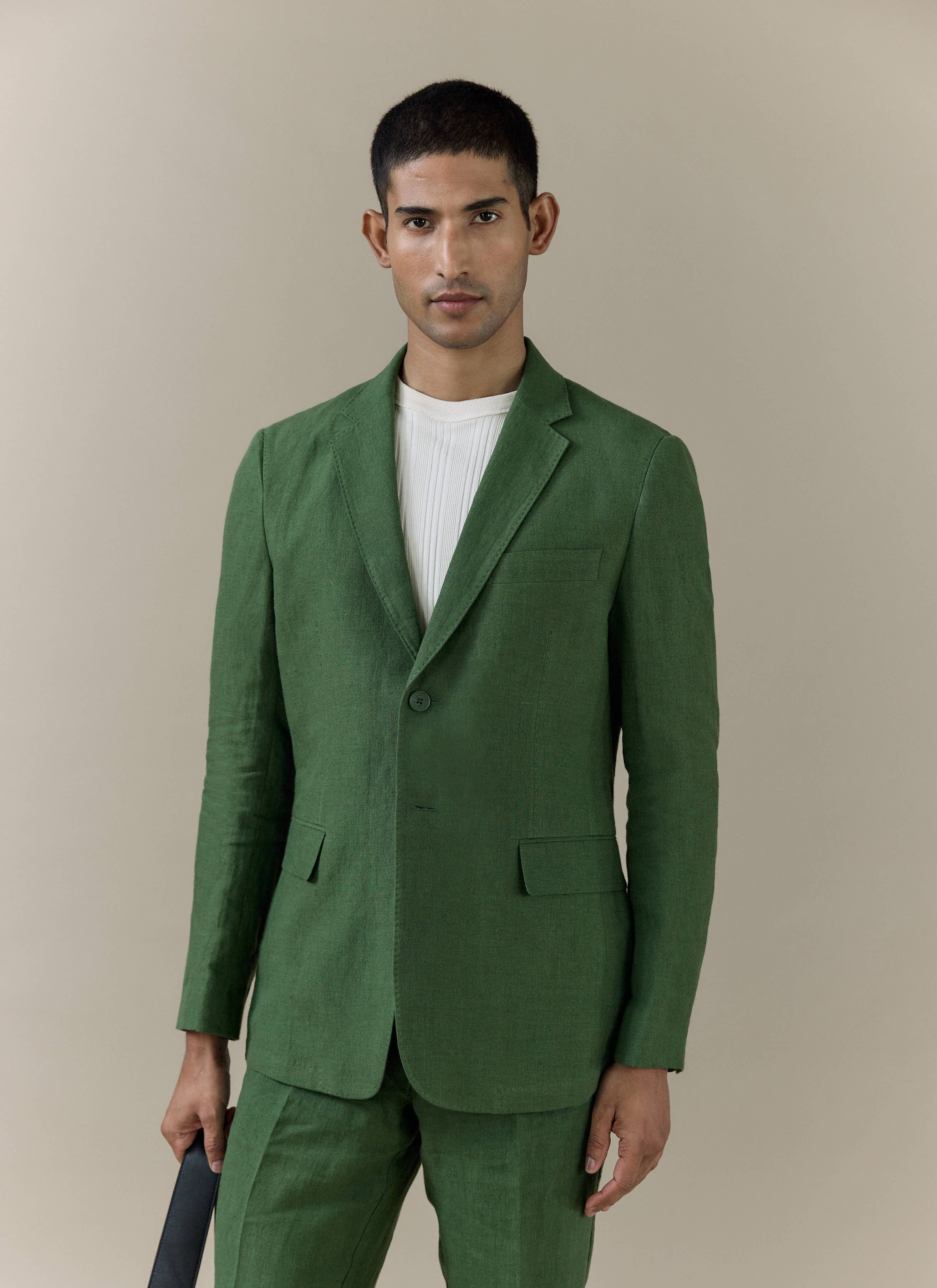 A model wearing the forest green Percival Slim Fit Classic Blazer in breathable linen against a neutral backdrop.