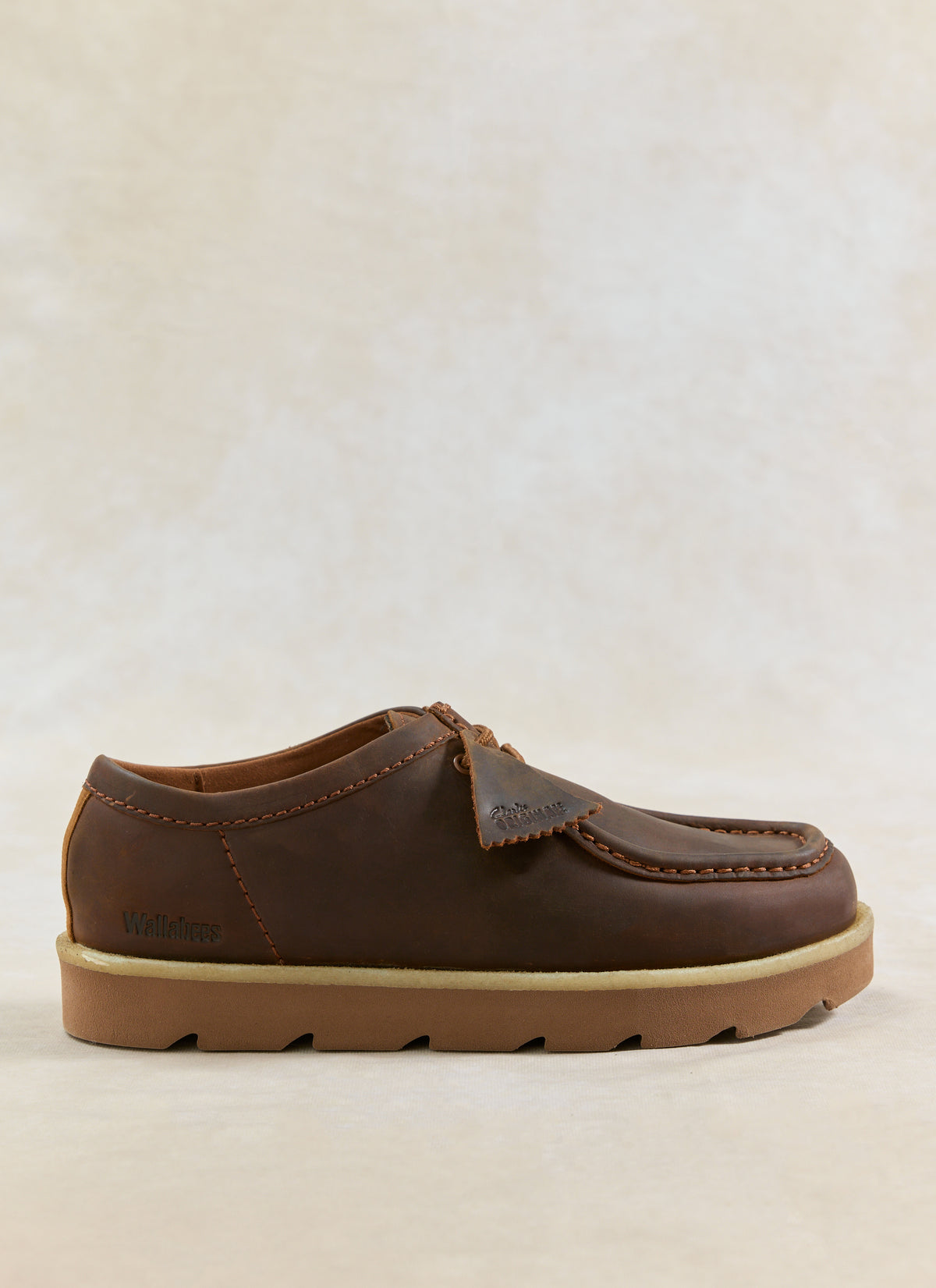 A side view of the Clarks Originals Meare Walla shoes in beeswax brown leather, showing the distinct moccasin construction.