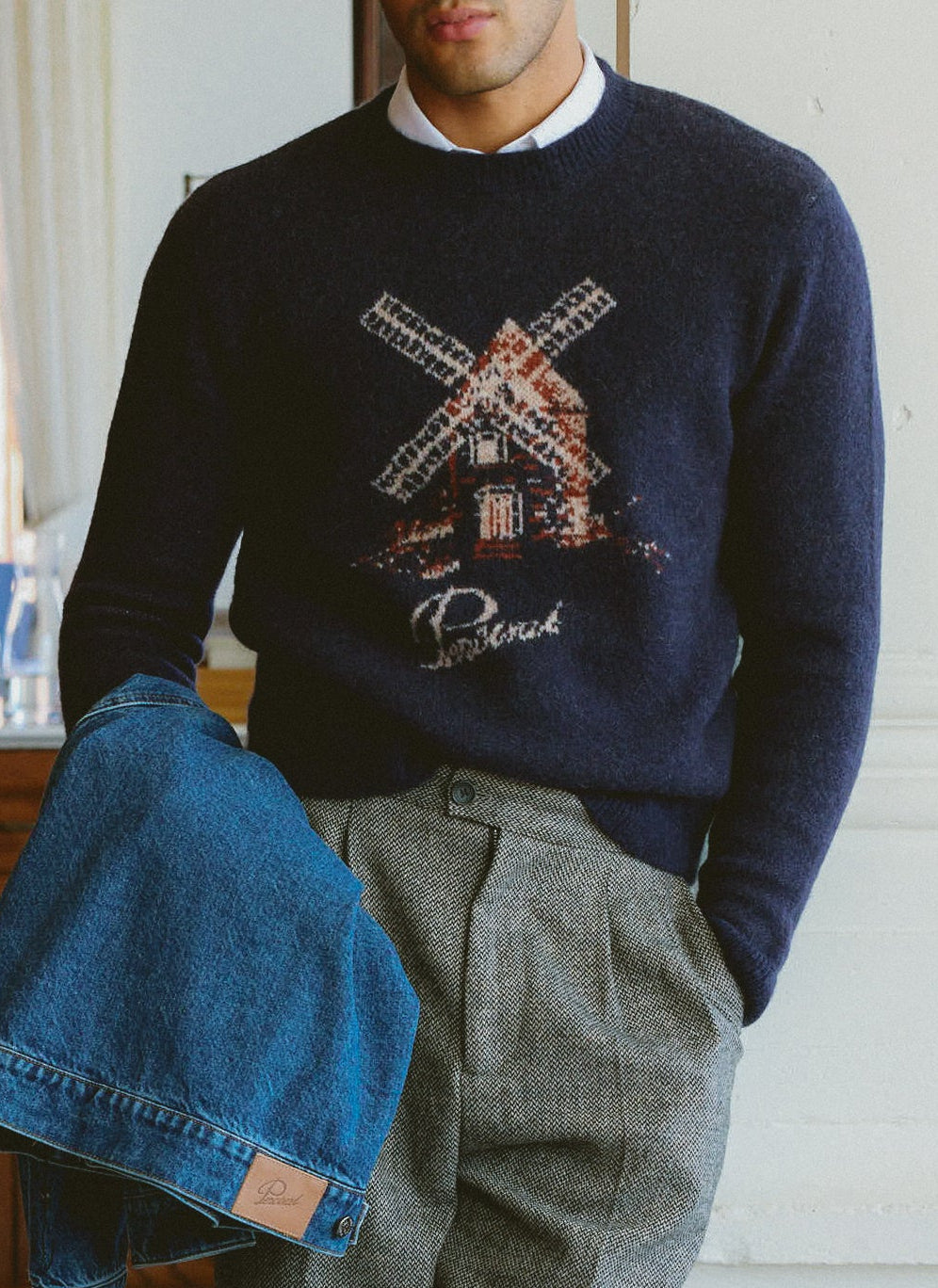 Navy Percival Miller Jacquard jumper in mohair wool, featuring a windmill graphic and worn over a white shirt.