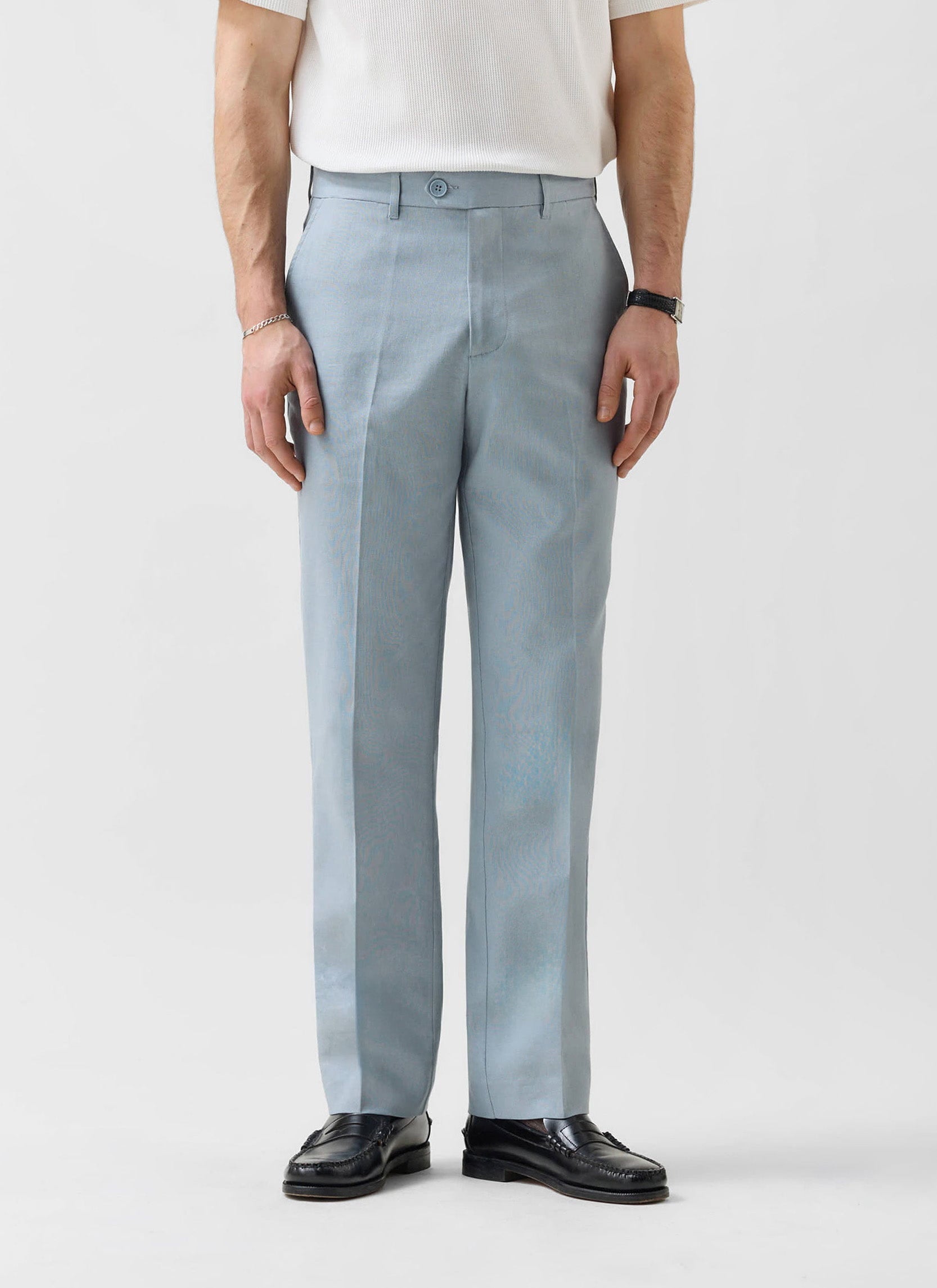 Percival light blue tailored linen trousers on a man wearing a white t-shirt and black loafers