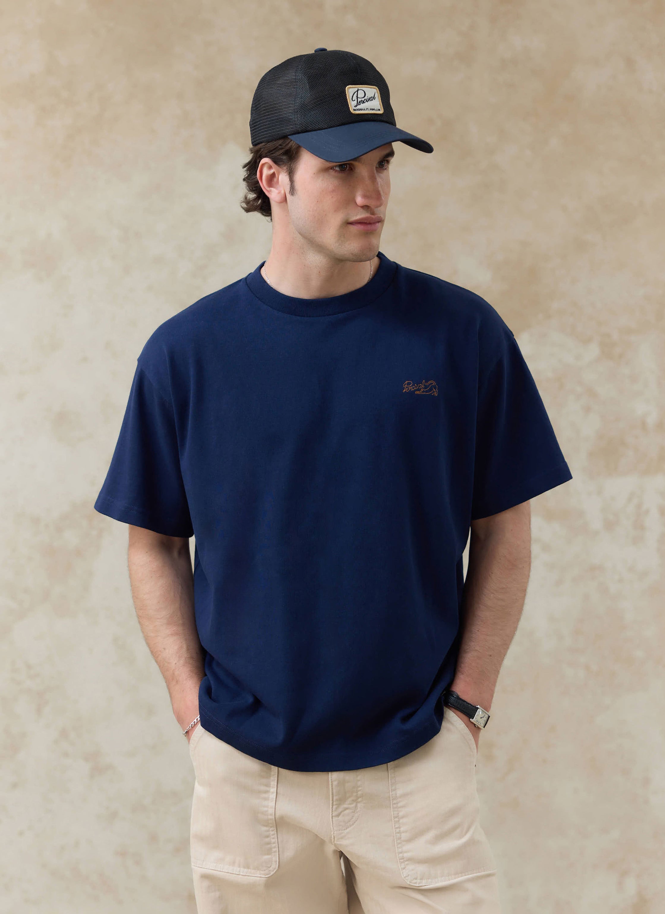 The Percival Navy Clarke T-Shirt in organic cotton with embroidery. Want more? Check out the full SS26 collection.