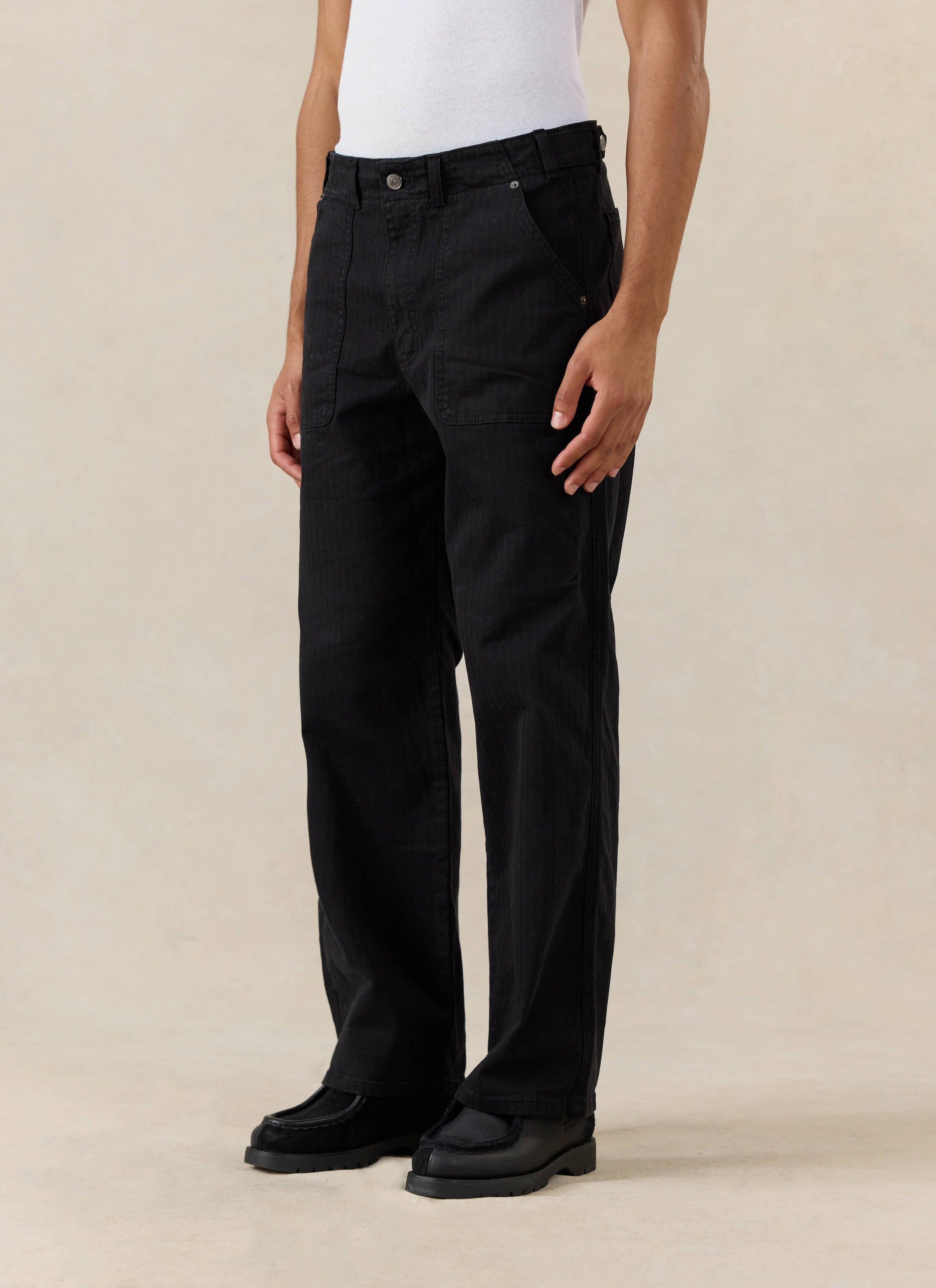 Black cotton Lungo Carpenter Trousers from Percival, featuring patch pockets and styled with a white vest.