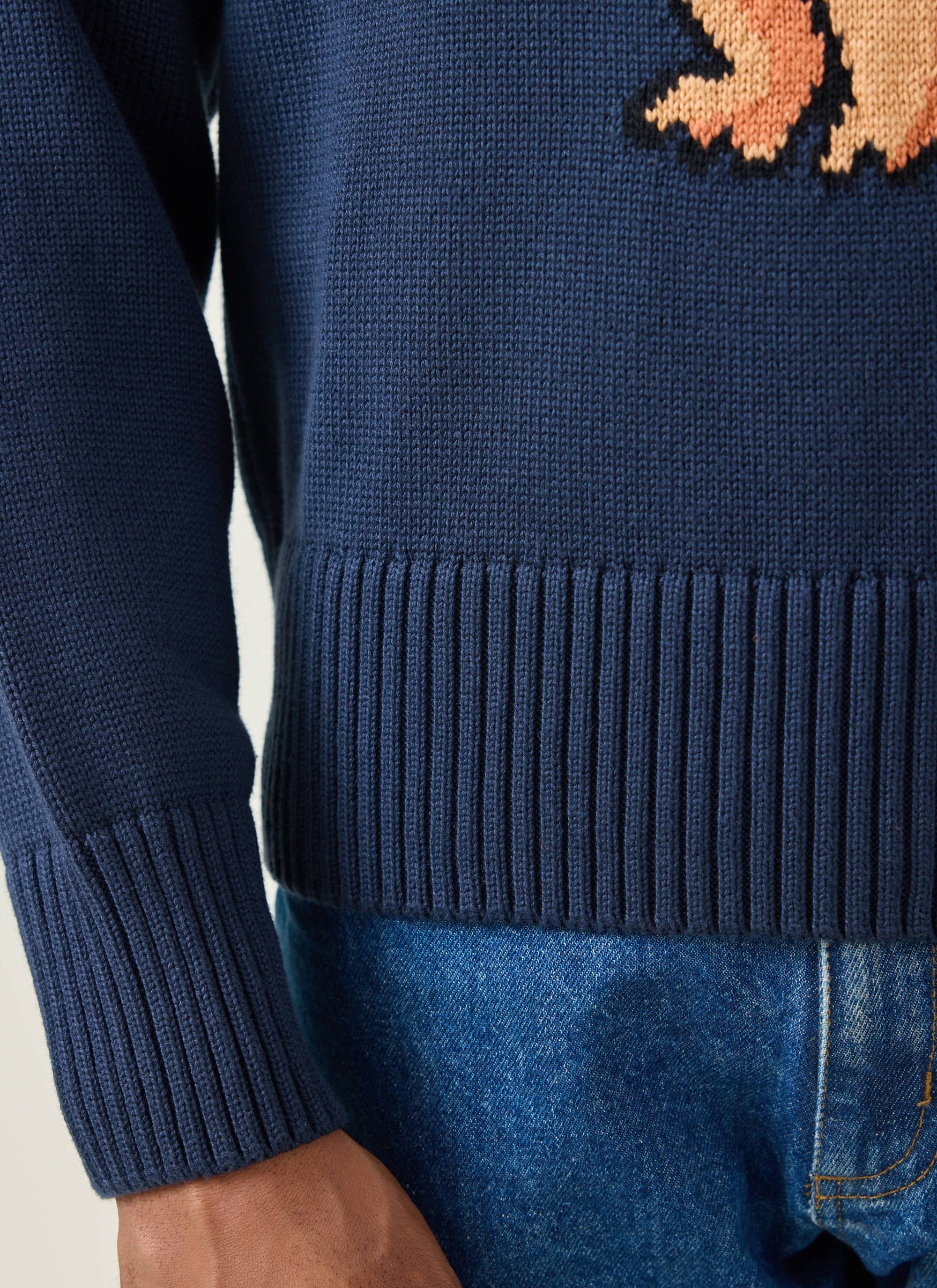 Close-up of the ribbed hem and cuff detail on the navy Jacquard Bear jumper from the Champion x Percival collection.