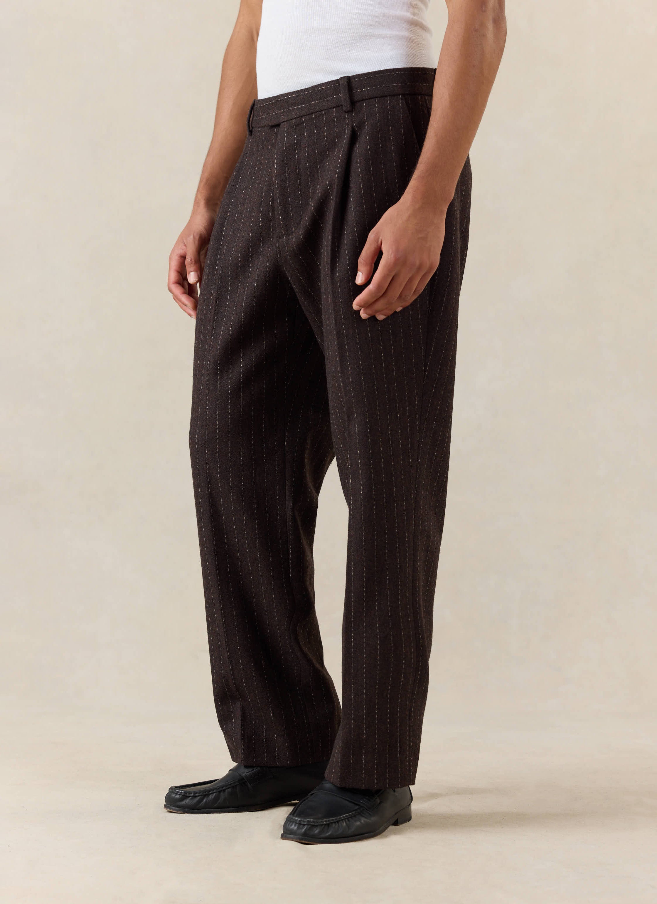 Percival Clifton Pinstripe Pleated Tailored Trousers in espresso wool blend, styled with a white vest and black loafers.