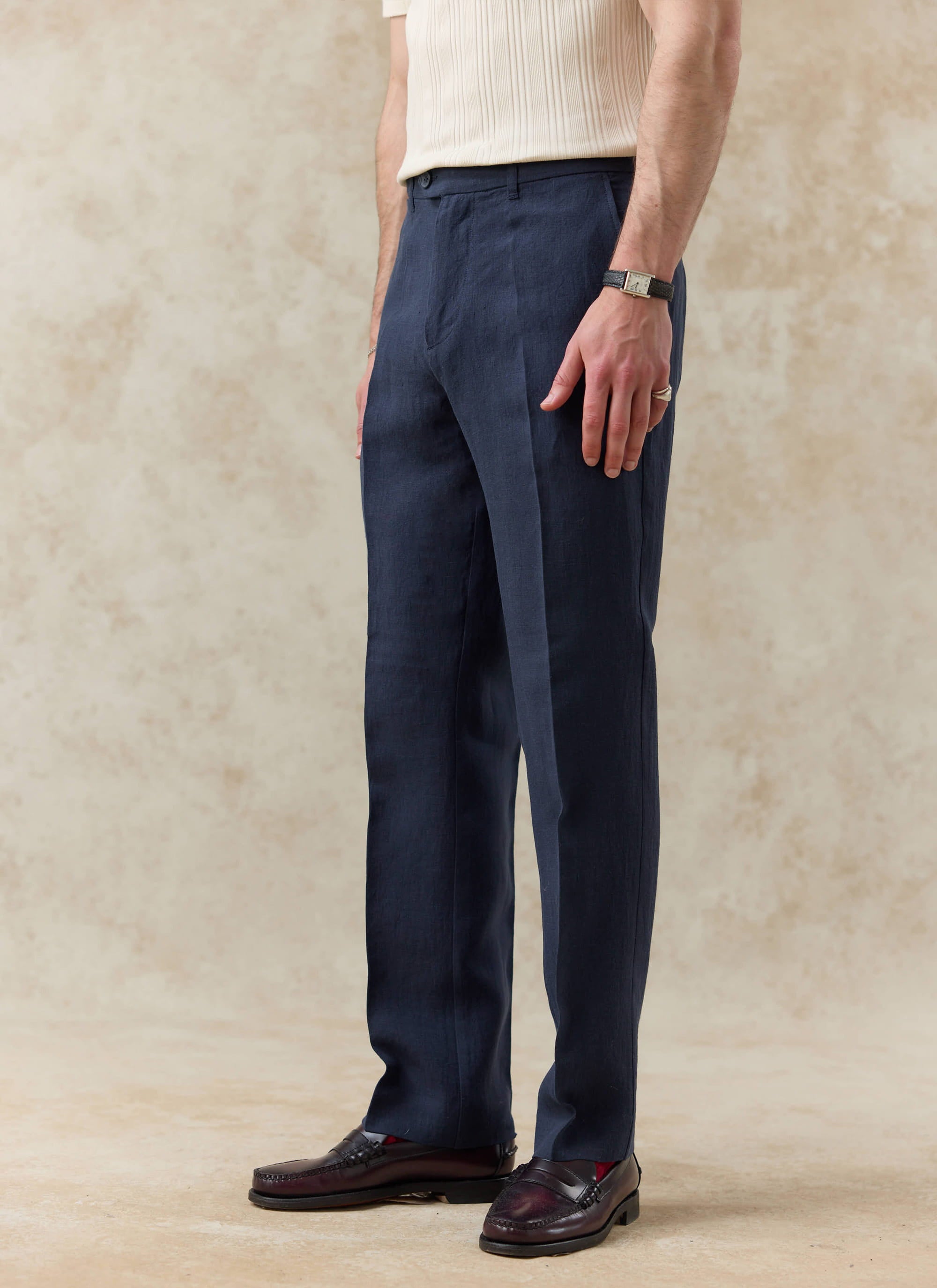 Tailored navy blue linen trousers by Percival, featuring a straight leg fit and a crisp central crease.