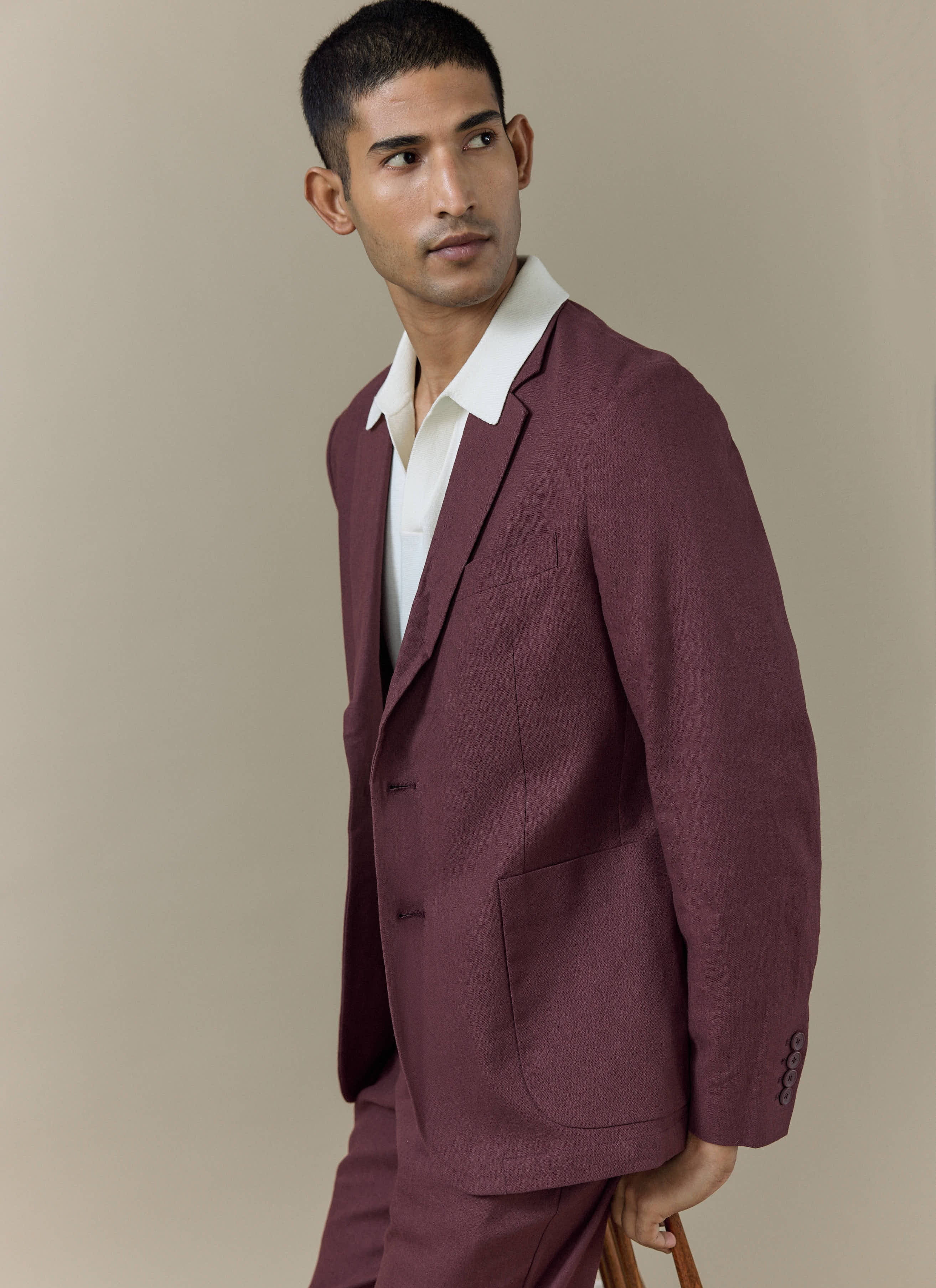 Percival Tailored Linen Blazer in merlot, worn by a model with matching trousers and a white polo shirt.