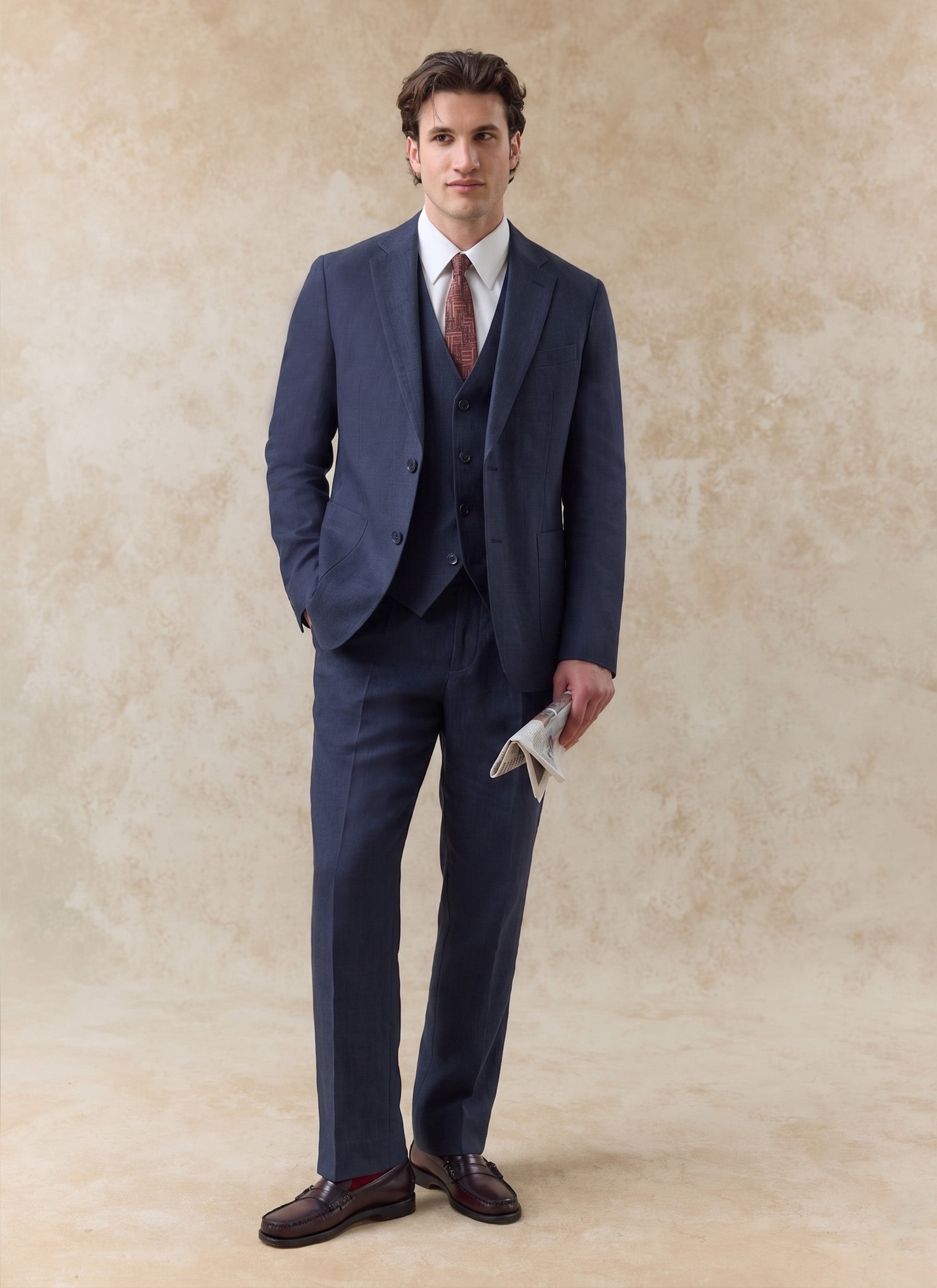 Navy blue linen waistcoat worn with a matching three-piece suit by Percival, featuring a white shirt and tie.