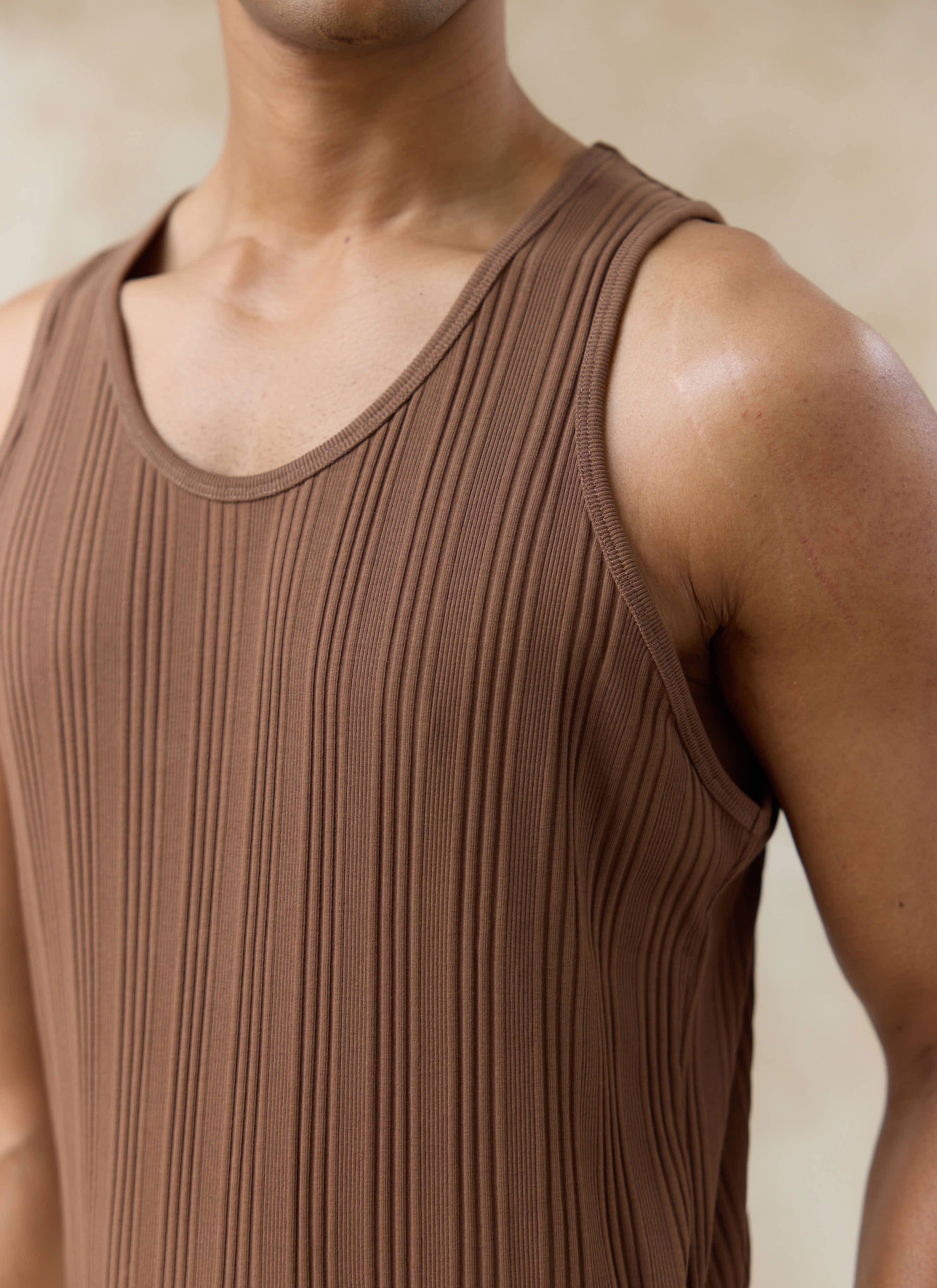 Close-up of the brown Percival Leon Ribbed Vest in organic cotton, highlighting the vertical rib and bound neckline.