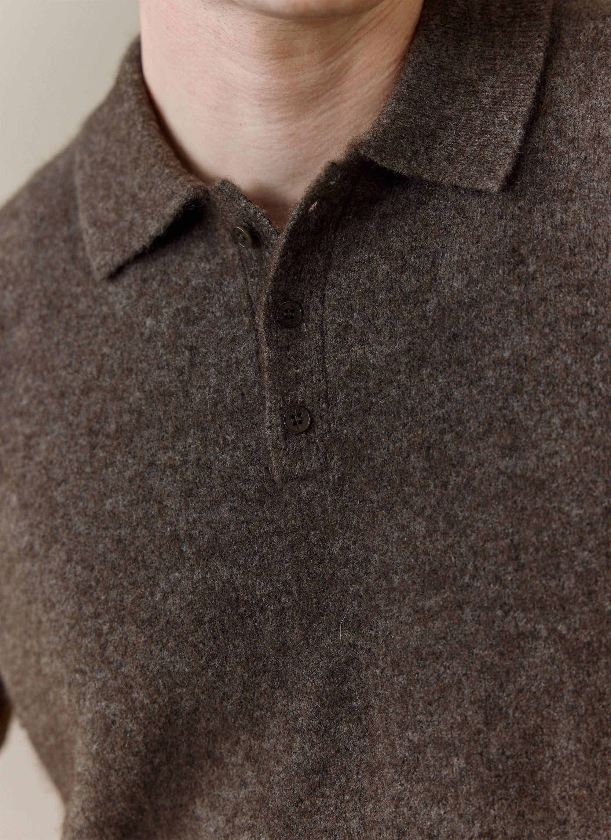 A close-up of the Percival Collins Boxy Knitted Polo in Espresso, showing the soft yak-wool blend fabric and button placket.