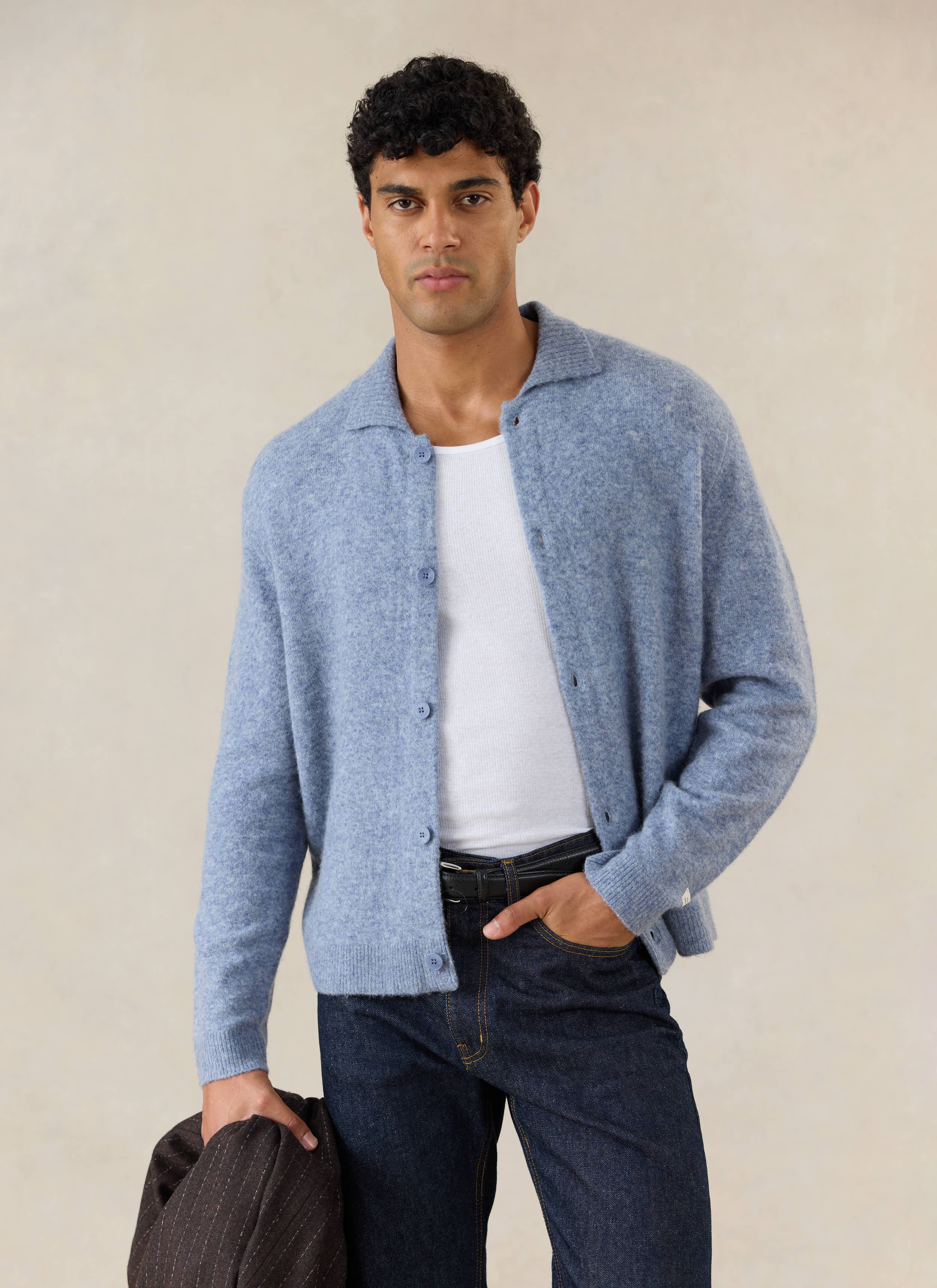 Heather blue Percival Archive Knit Collared Cardigan in yak wool, styled with a white vest and dark denim jeans.