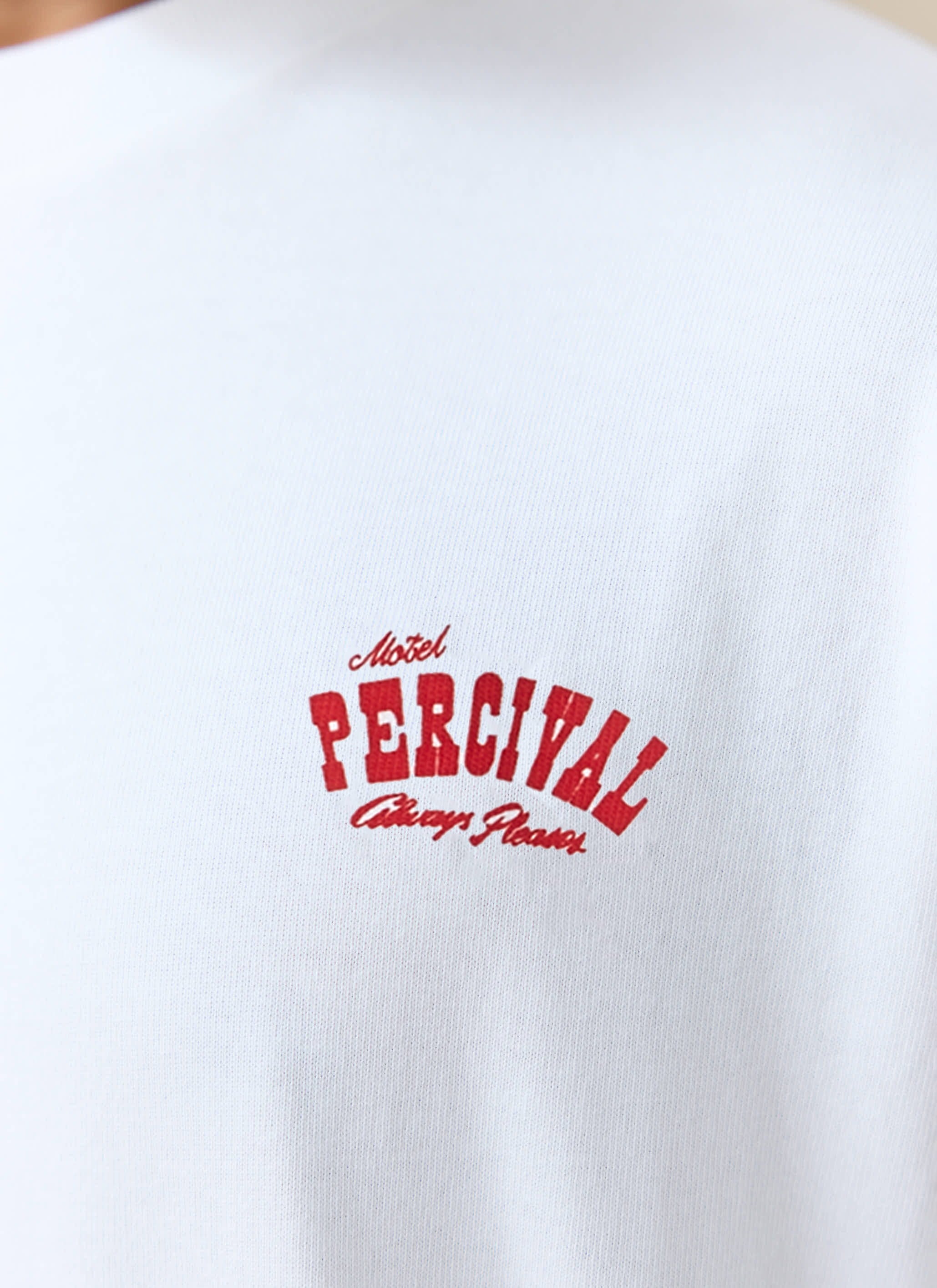 Close-up of the red Motel chest print on the white organic cotton Gordon Oversized T-shirt from Percival.