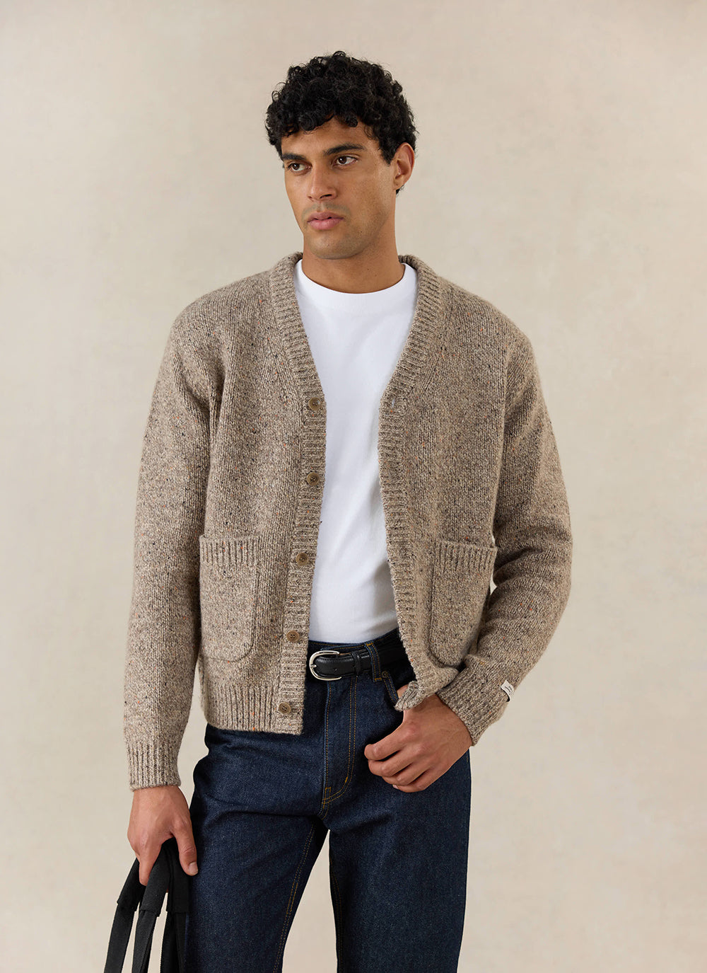 A model wears the oak Percival Rhodes Cardigan, styled with a white tee and dark jeans.