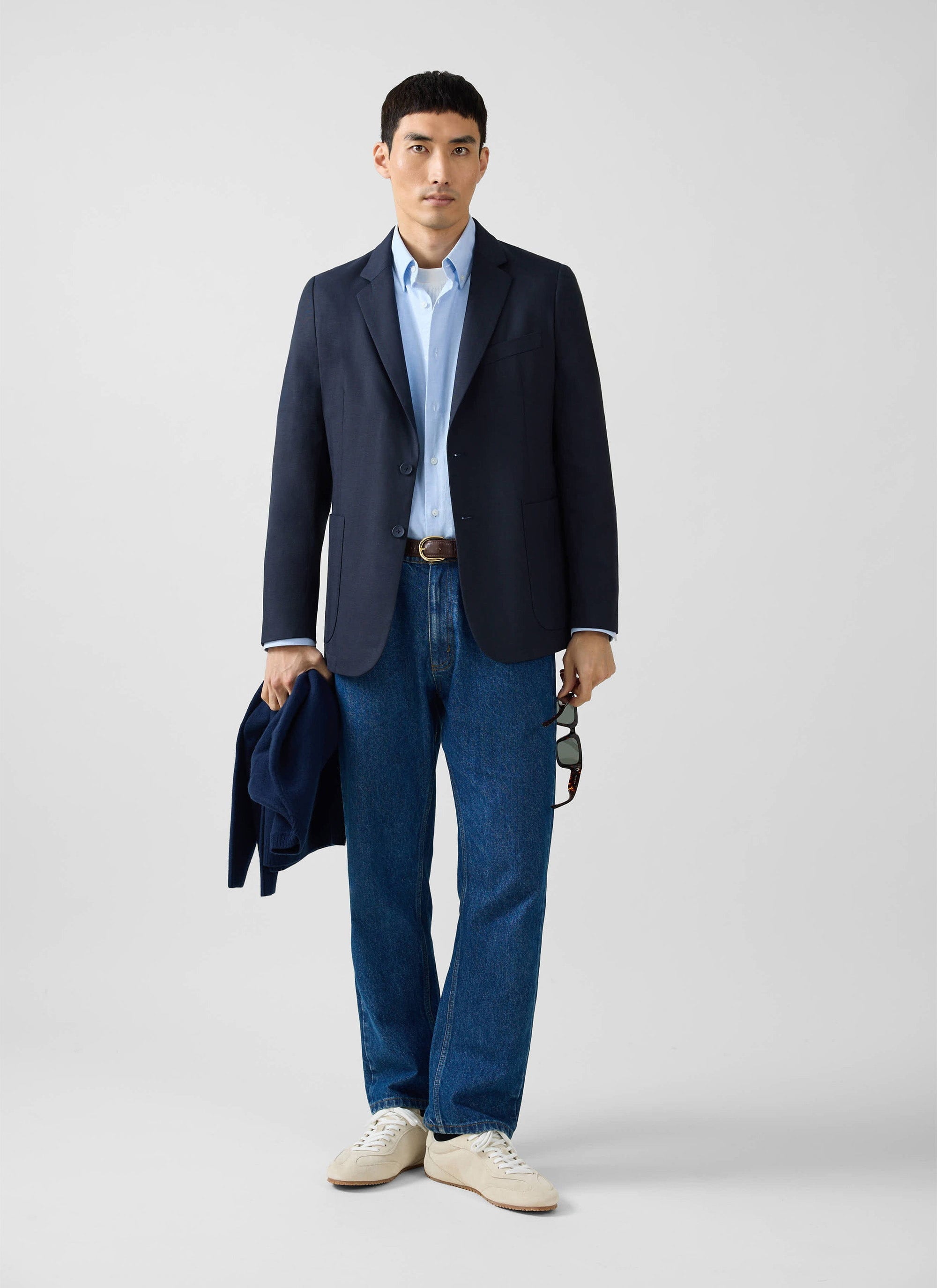 A model wears the Percival navy Lyocell Regular Blazer, paired with a light blue shirt and dark blue jeans.