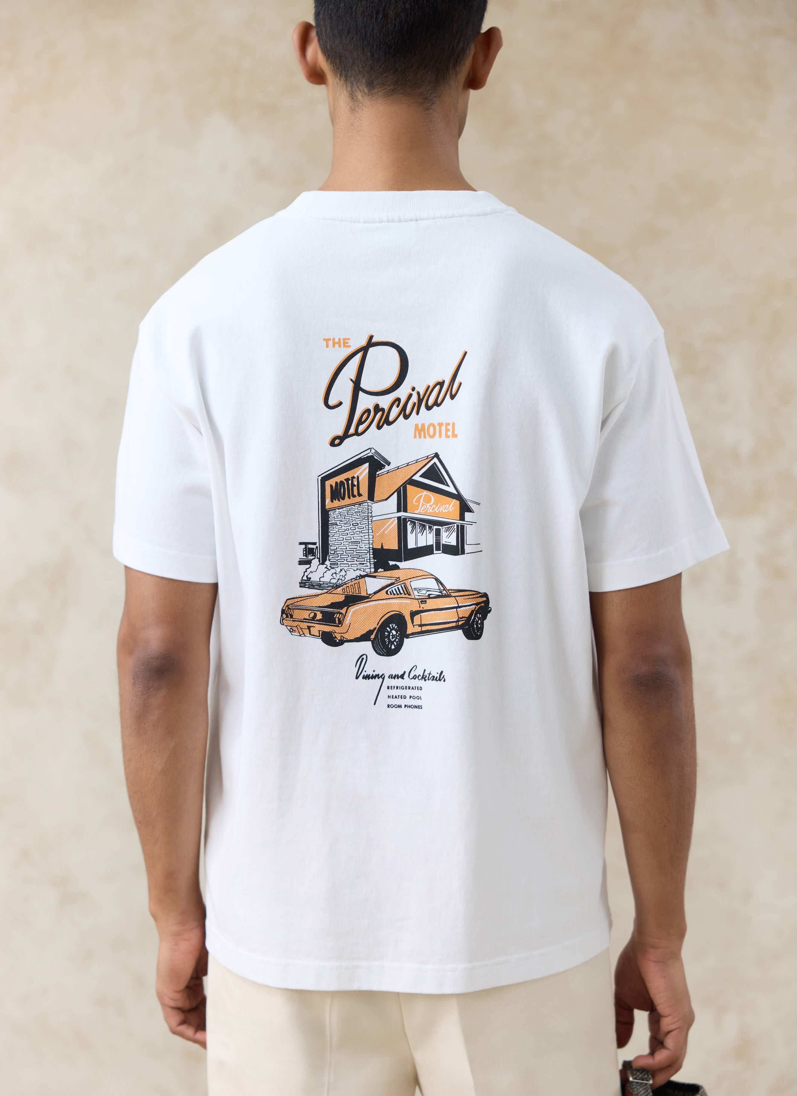 White Percival Alistair Oversized T-Shirt shown from the back, featuring a large vintage motel and car graphic.