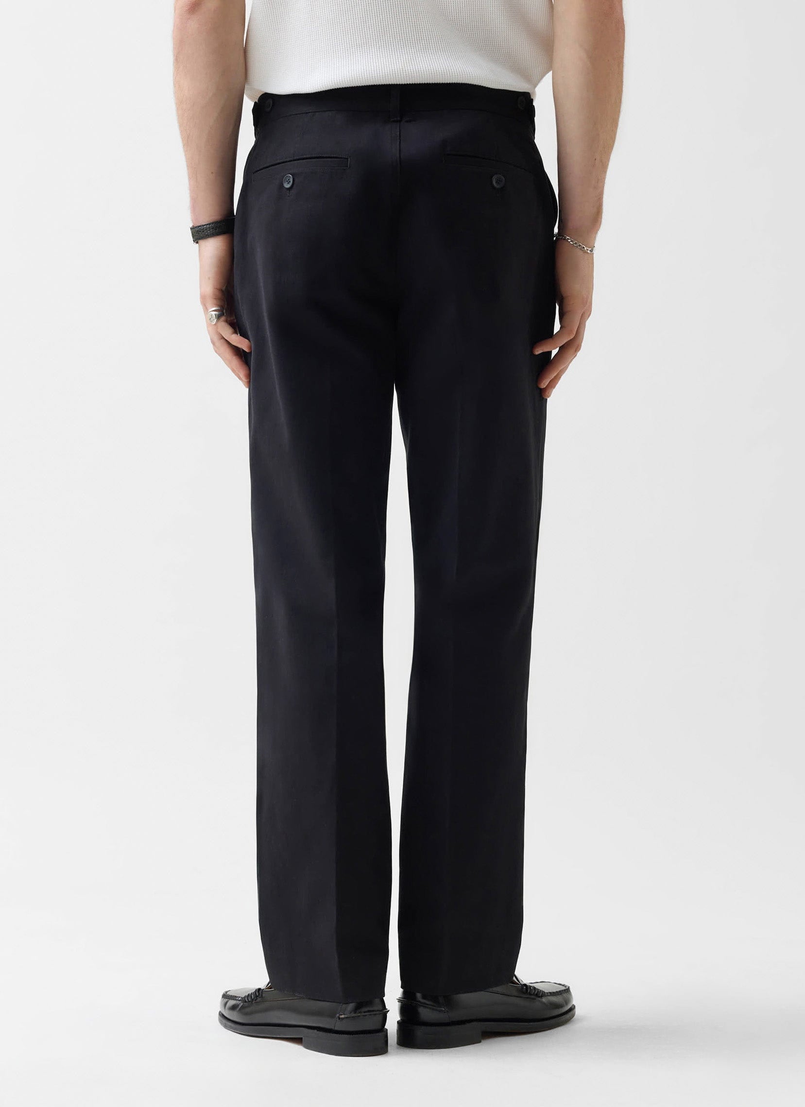 A model shot from behind wears the Percival Straight Leg Chino in black, showing the fit and rear pocket details.