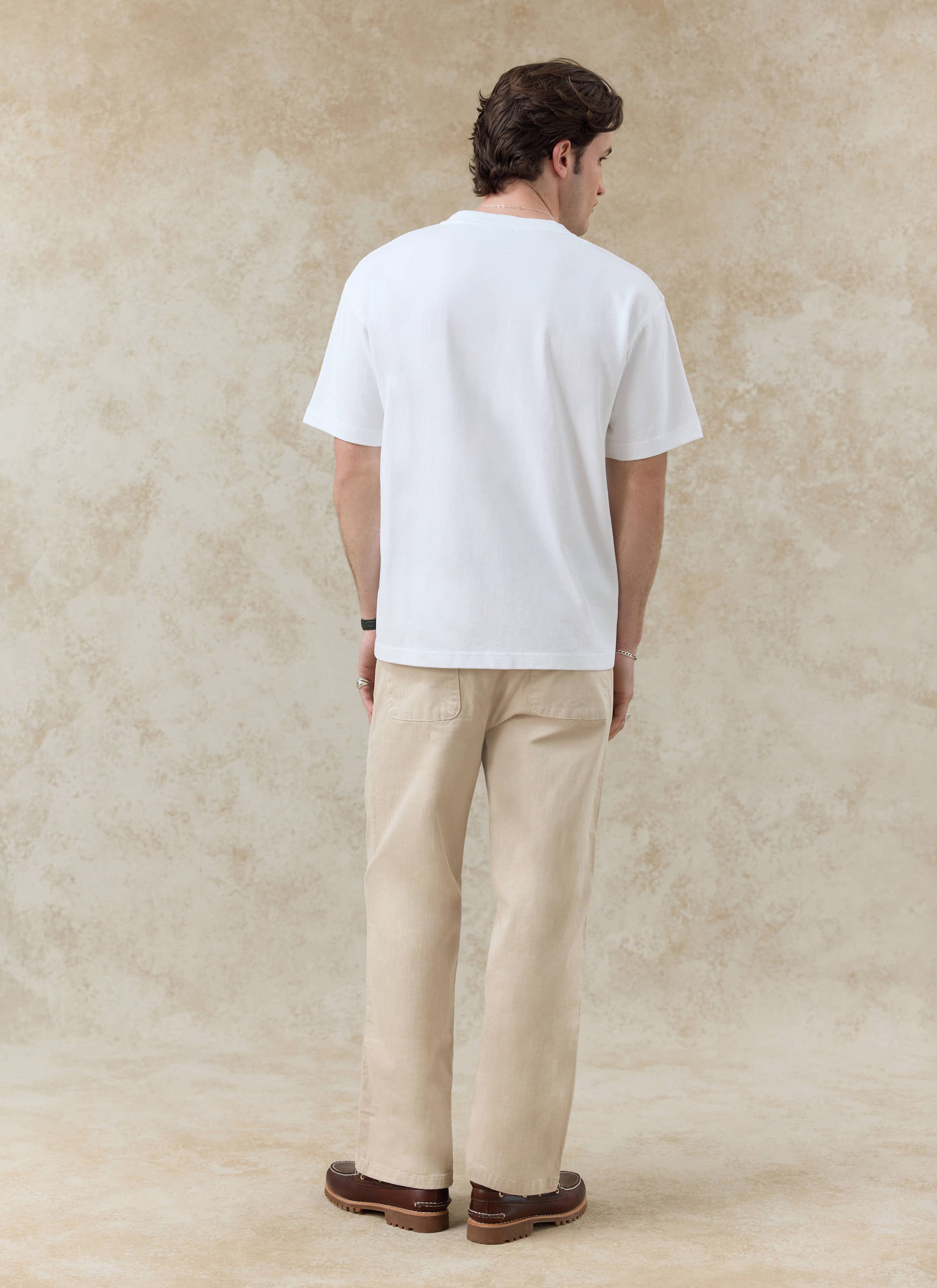 White organic cotton Palmer Embroidered T-Shirt by Percival, captured from a rear angle on a model.