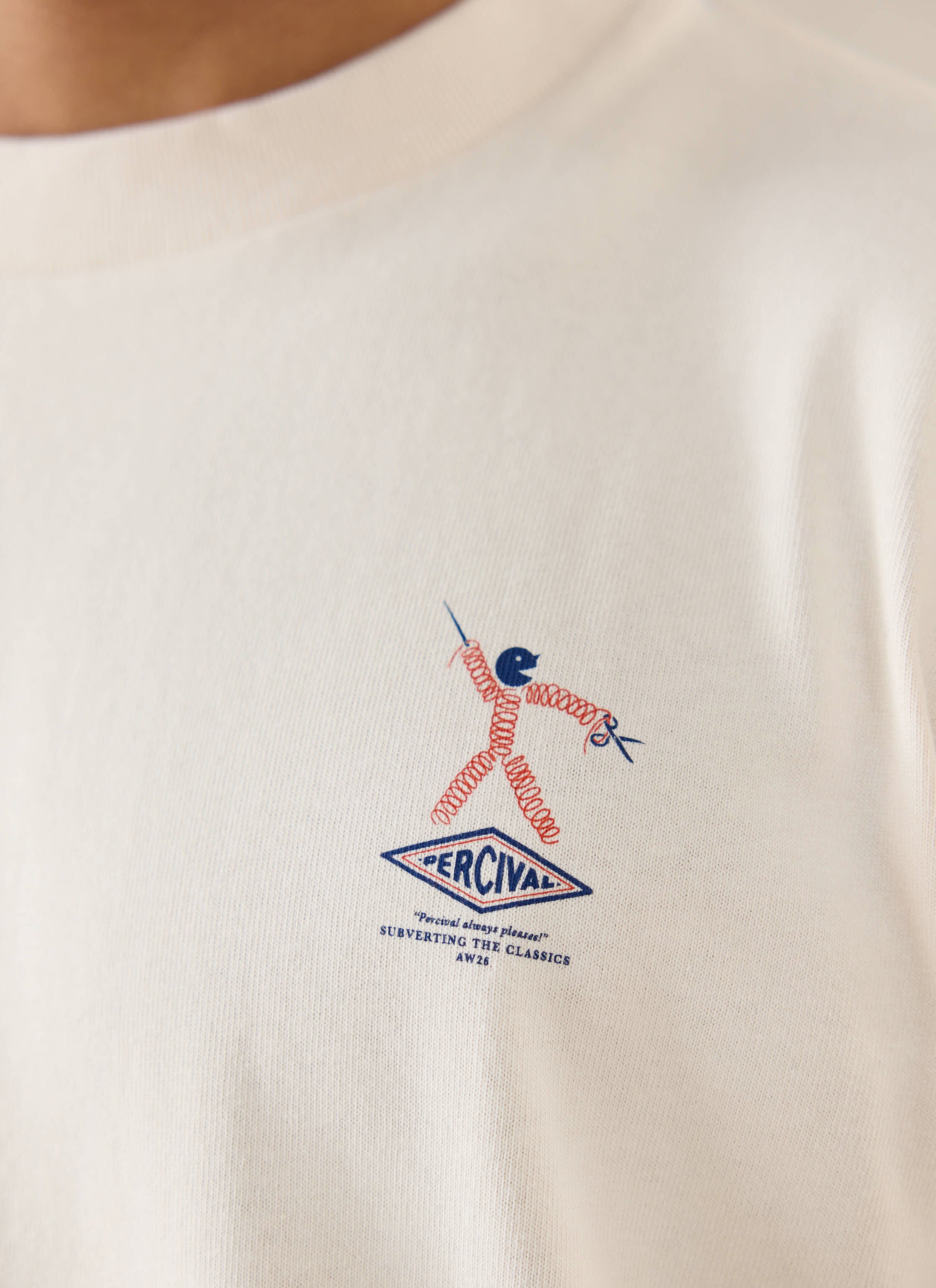 A close-up of a model wearing a Percival graphic t-shirt, showing the detailed chest logo.