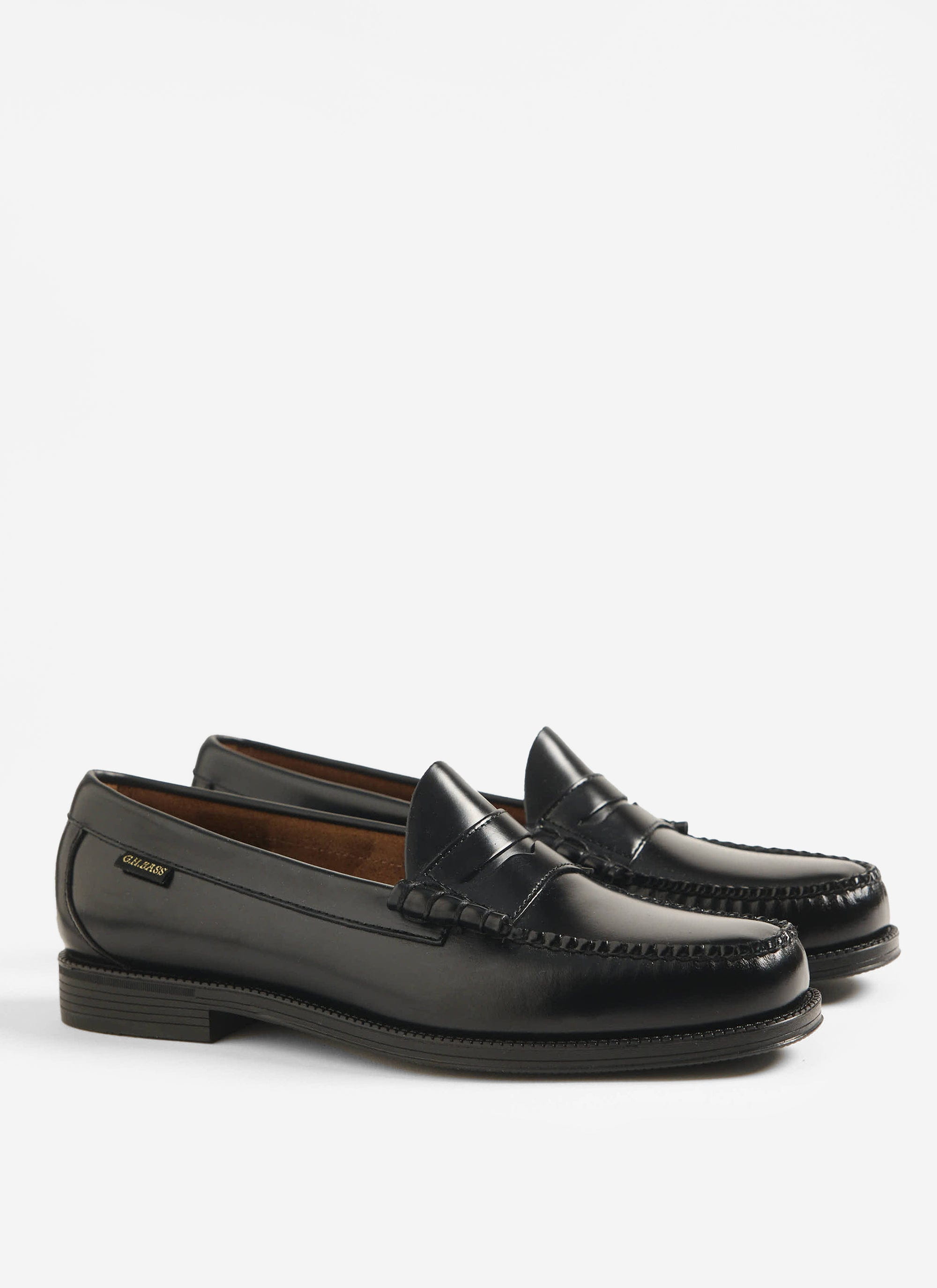 The G.H. Bass Weejuns Larson Flag penny loafers in black polished leather, available at Percival, against a white background.