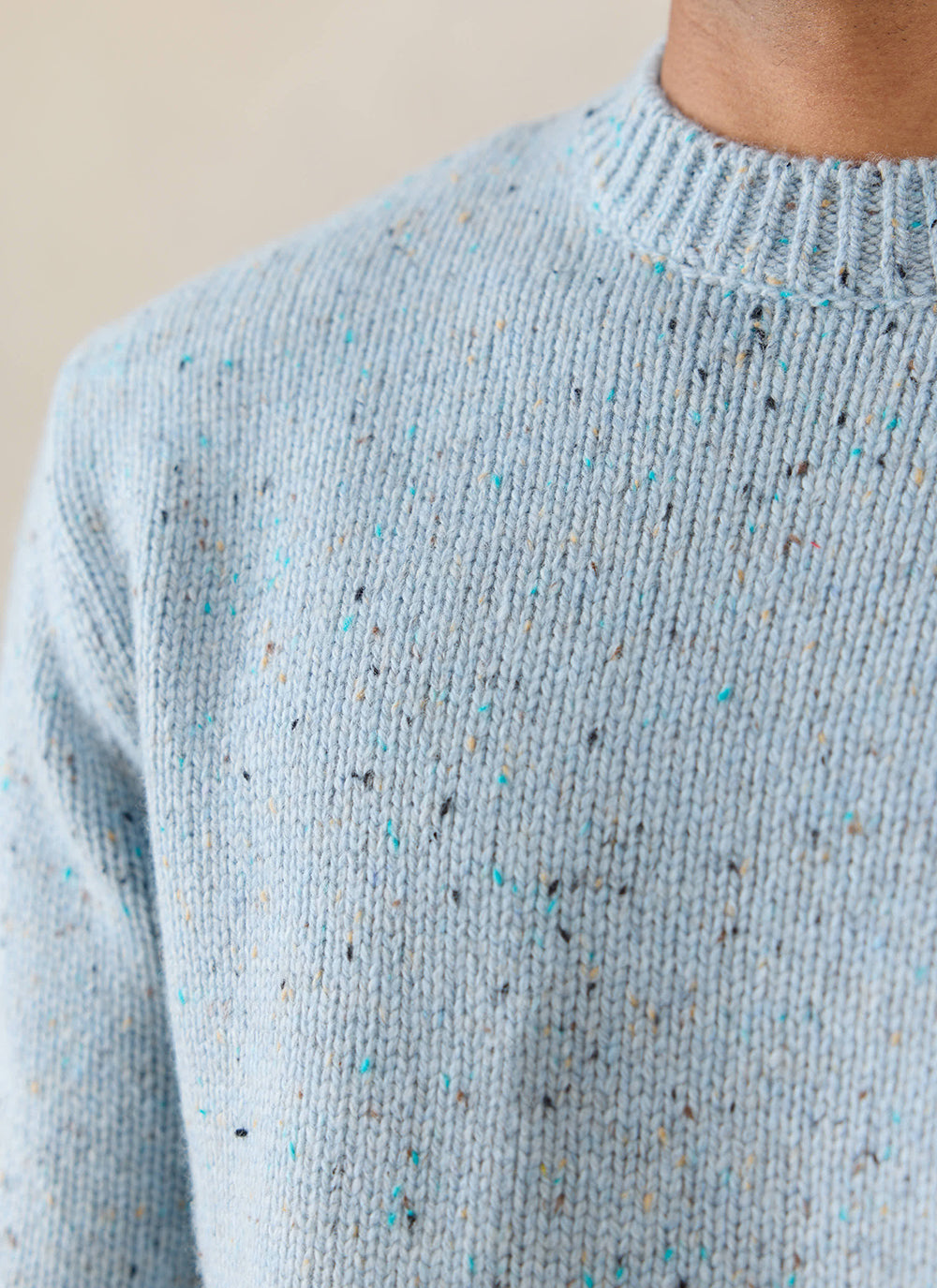 Close-up of the blue Percival Rhodes crew neck jumper, showcasing its flecked cotton-blend knit texture.